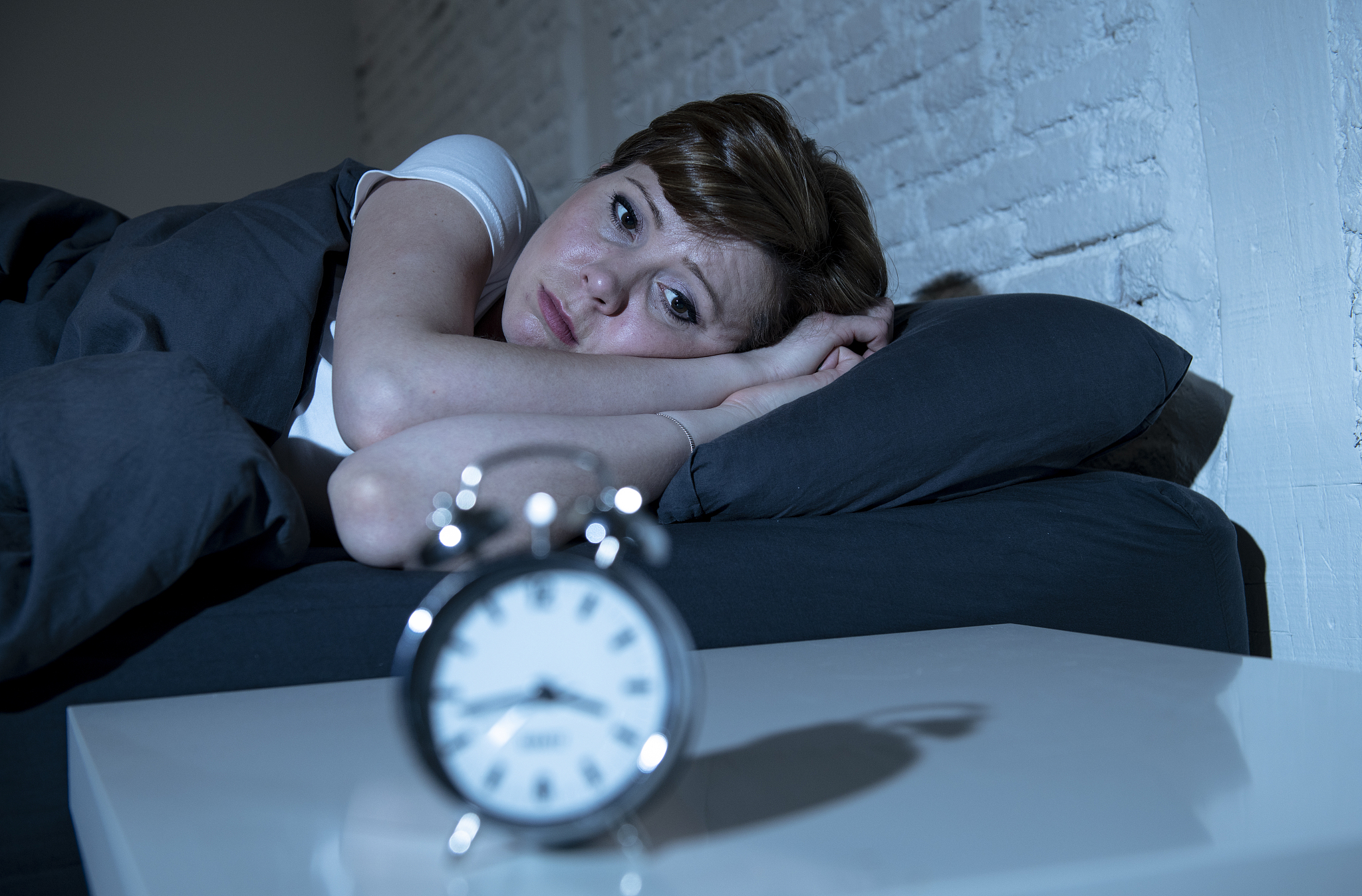 young attractive red haired caucasian woman lying in bed late at