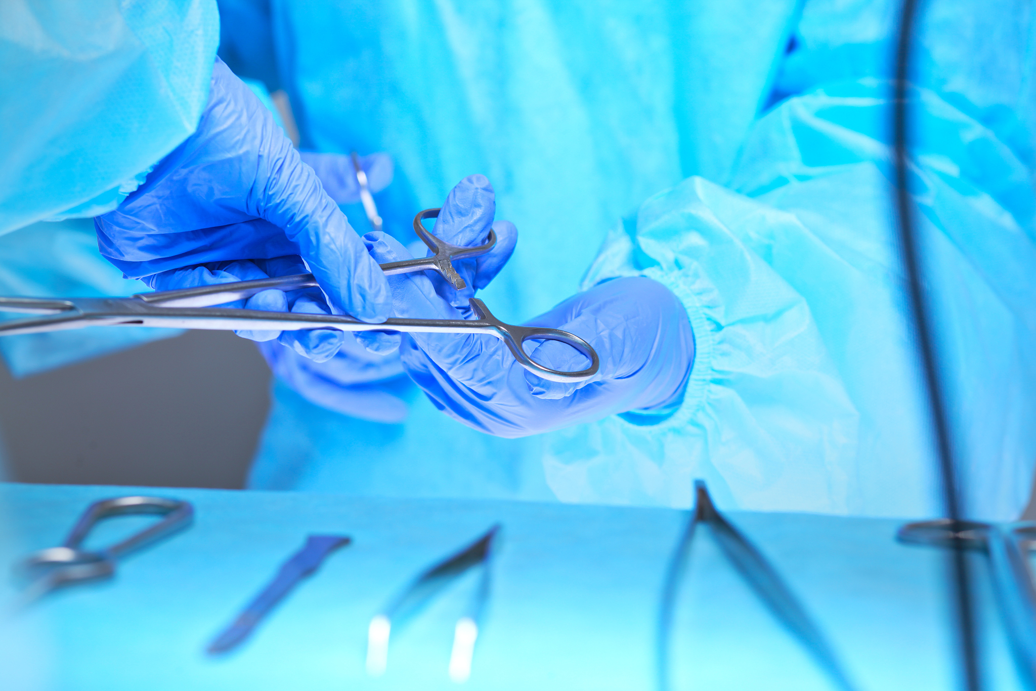 close-up of of surgeons hands at work in operating theater toned