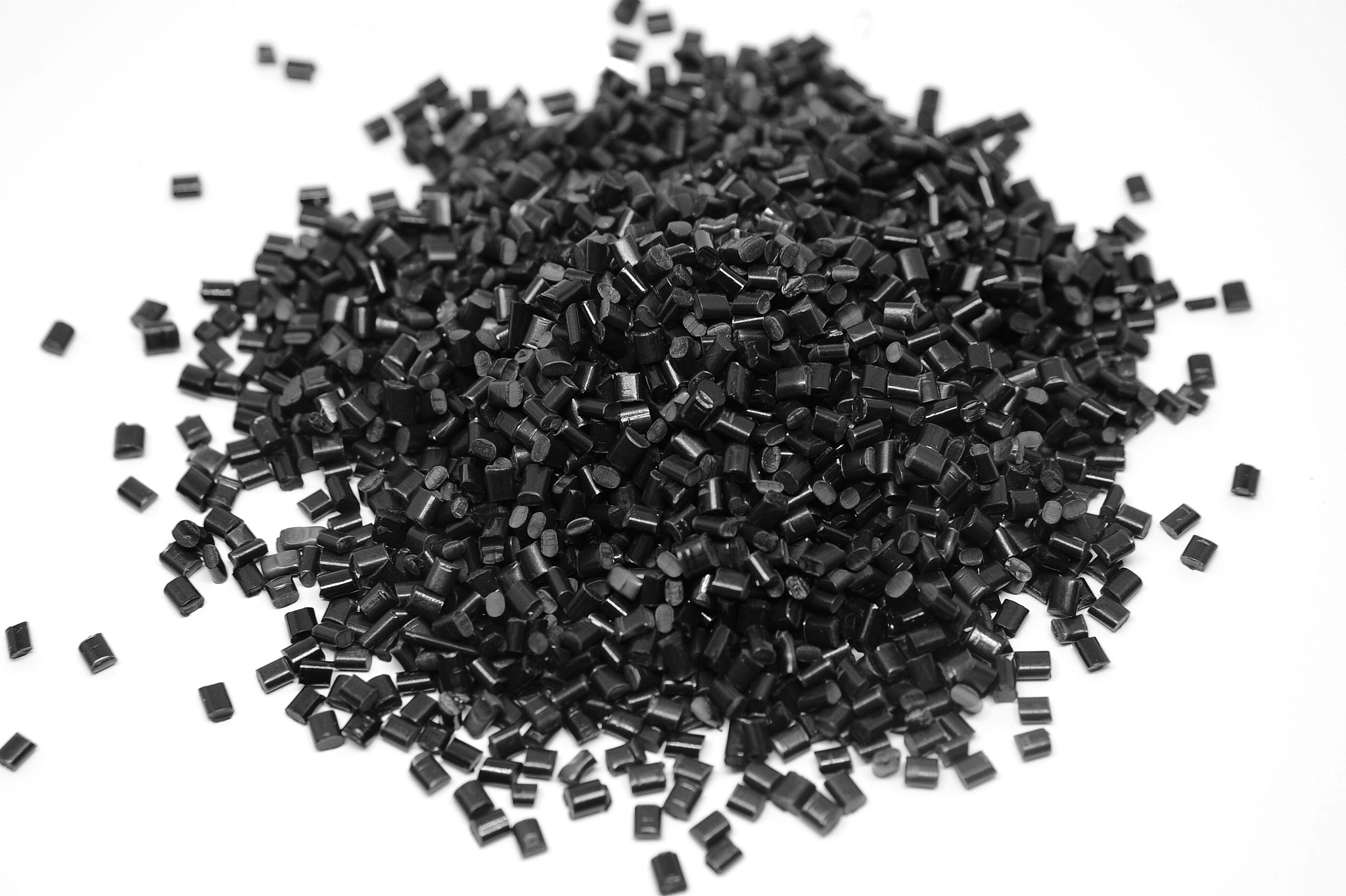 black plastic polymer granules isolated on white