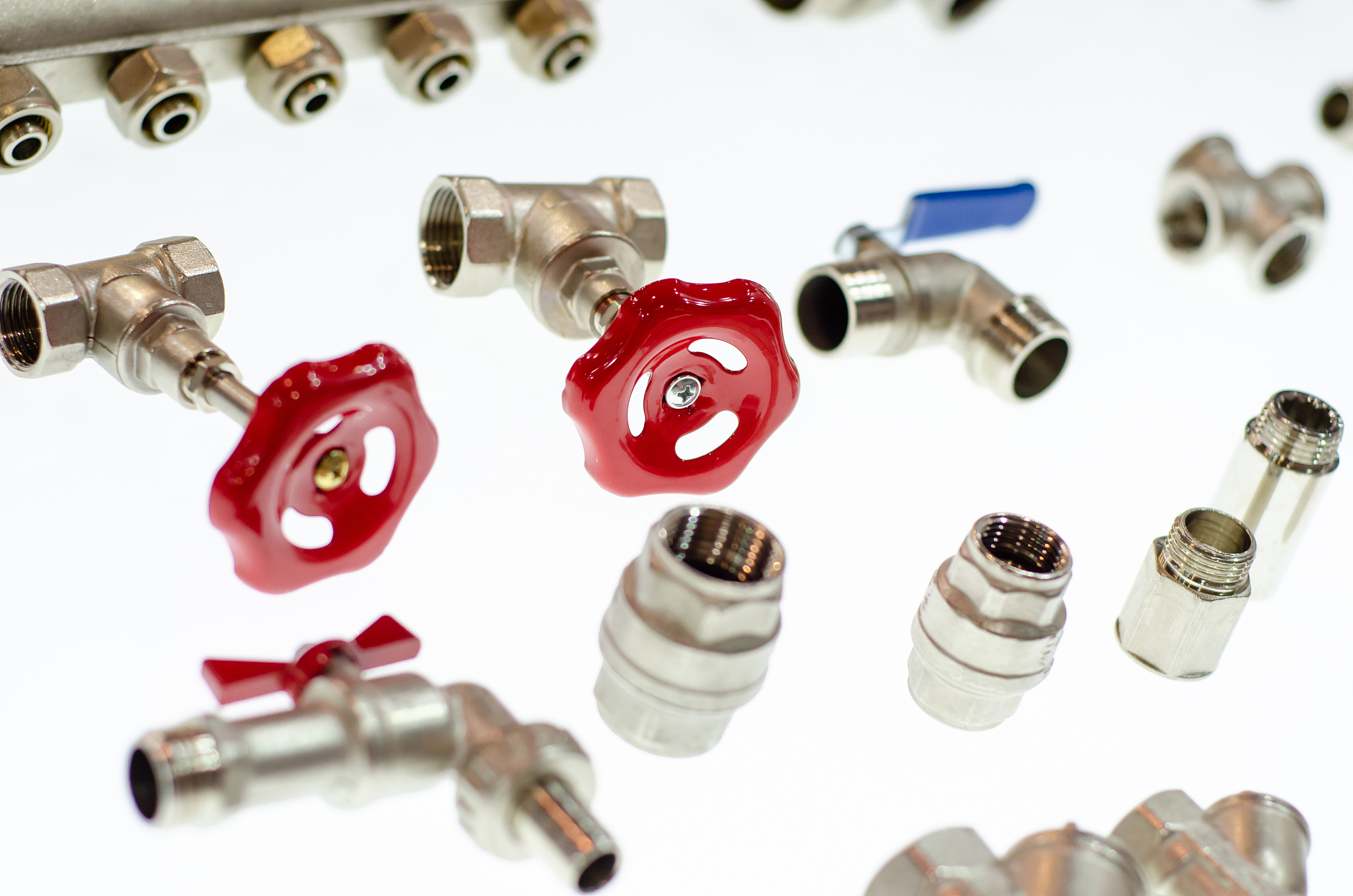 close-up of different ball valves and metal adapters for pipes.