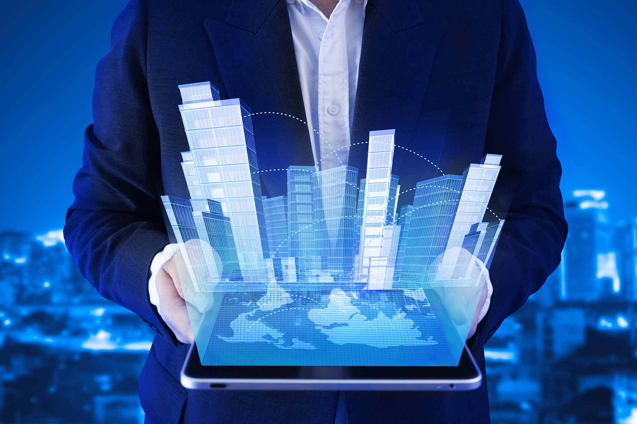 businessman hold tablet which show halogram futuristic city and 
