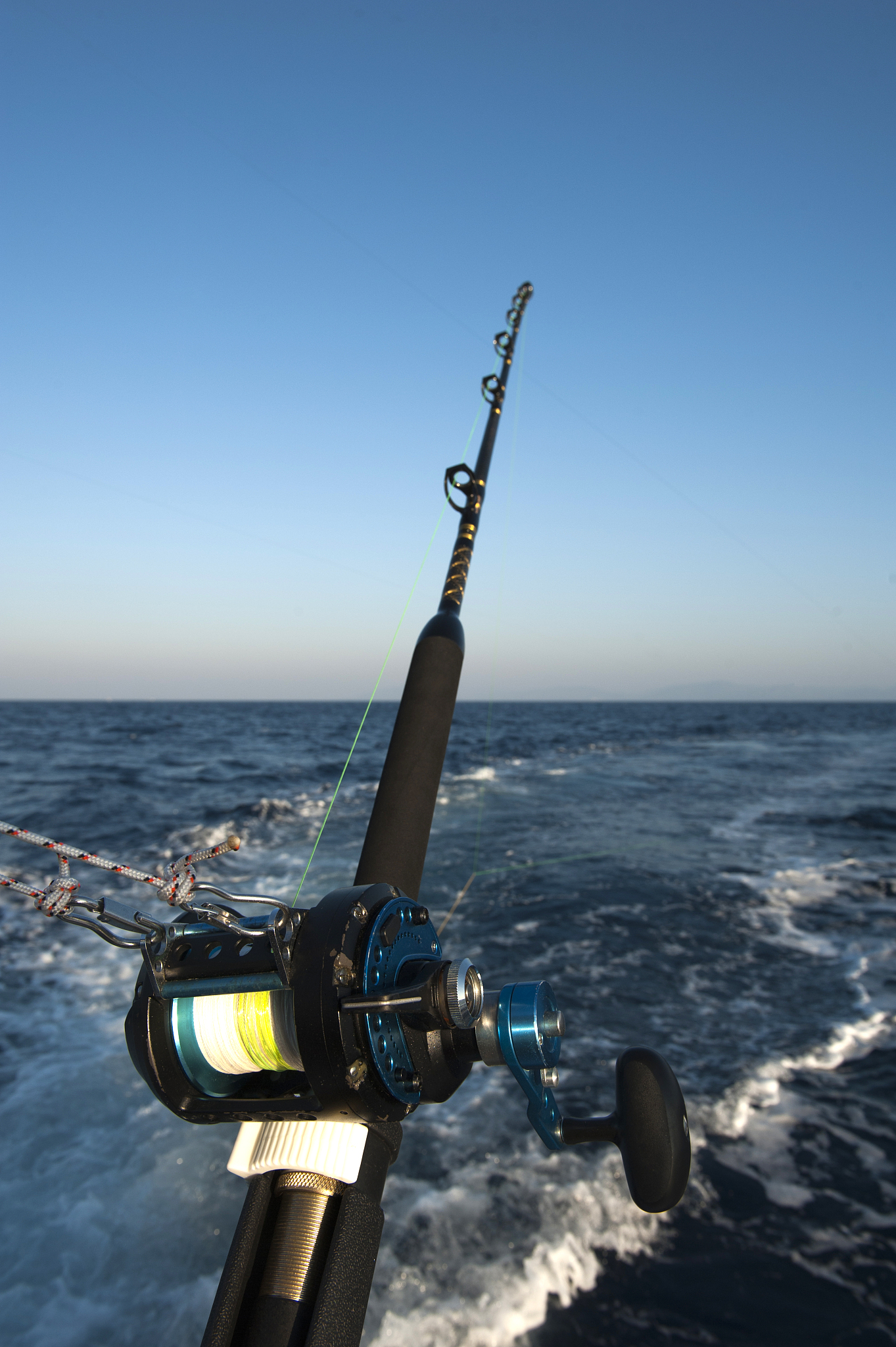 fishing reel and rod on motorboat