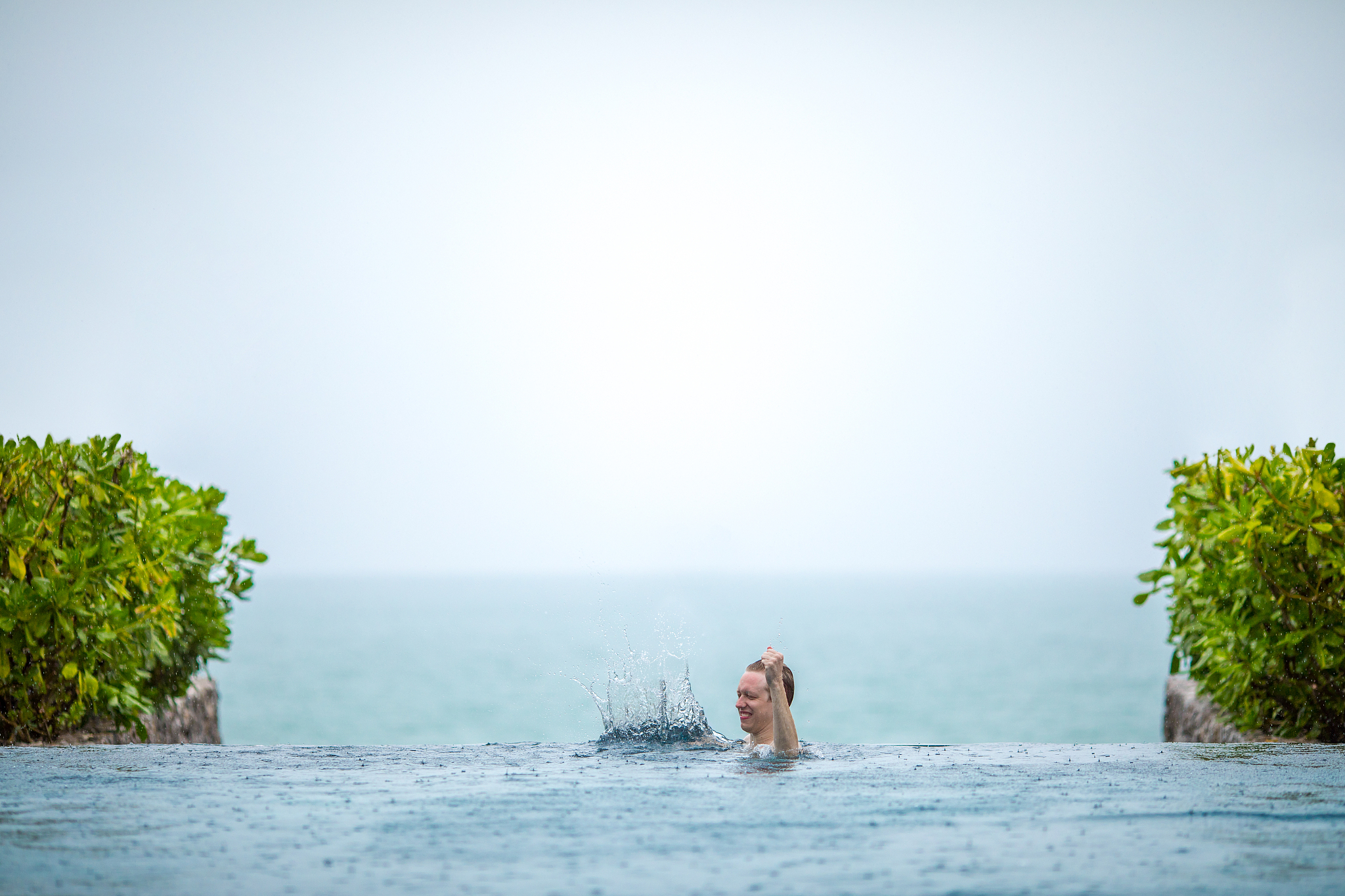 young man basking in the infinity pool