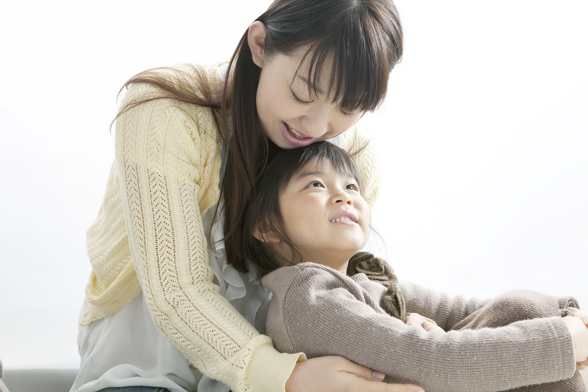 a mother and a daughter who sit indoors