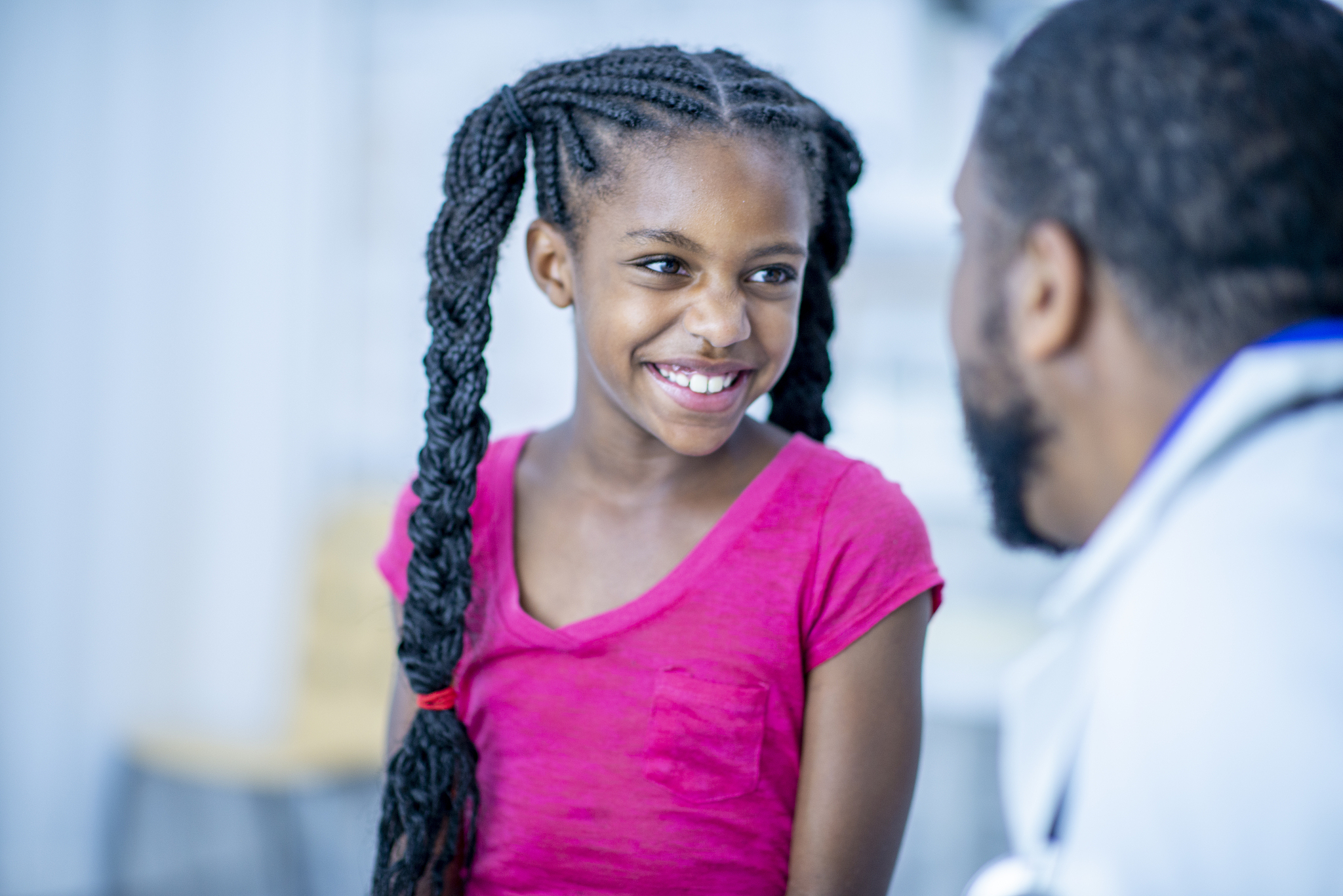 adorable patient smiles at her doctor