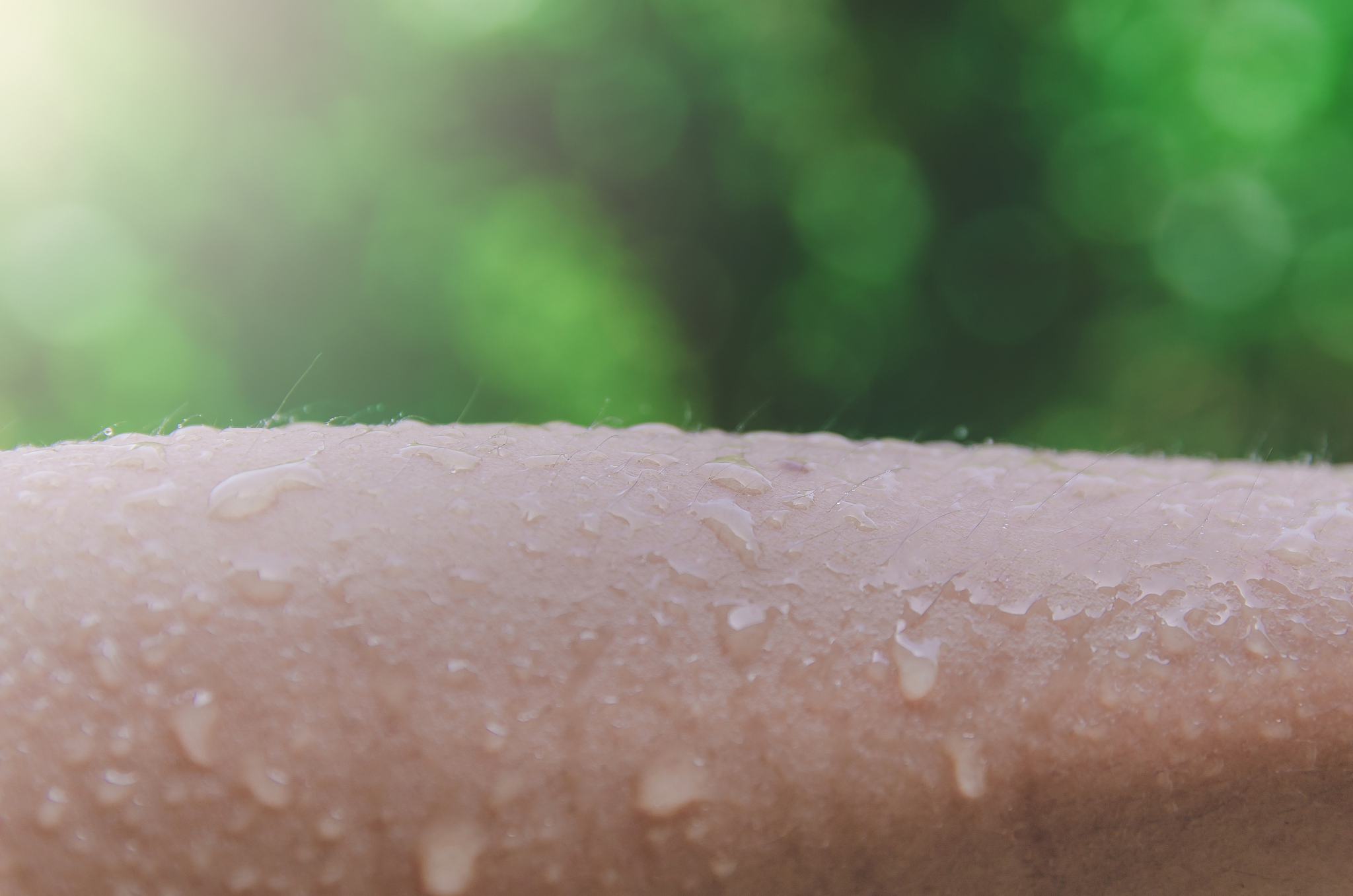 human skin with water drop and water spread, droplet of water on