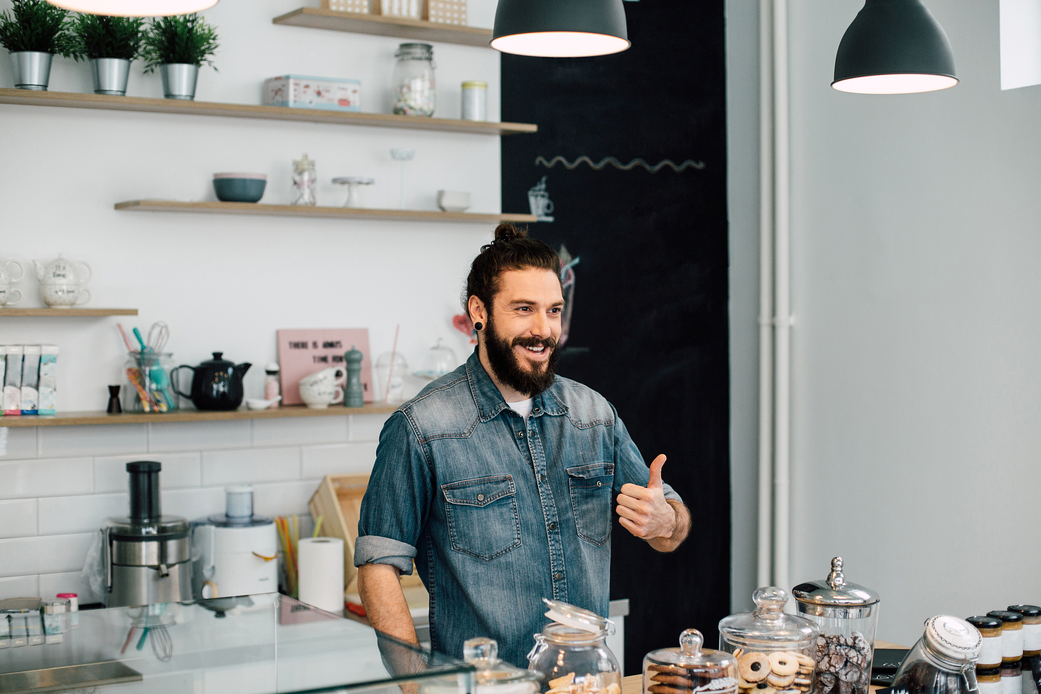 happy man pointing thumbs up at the store