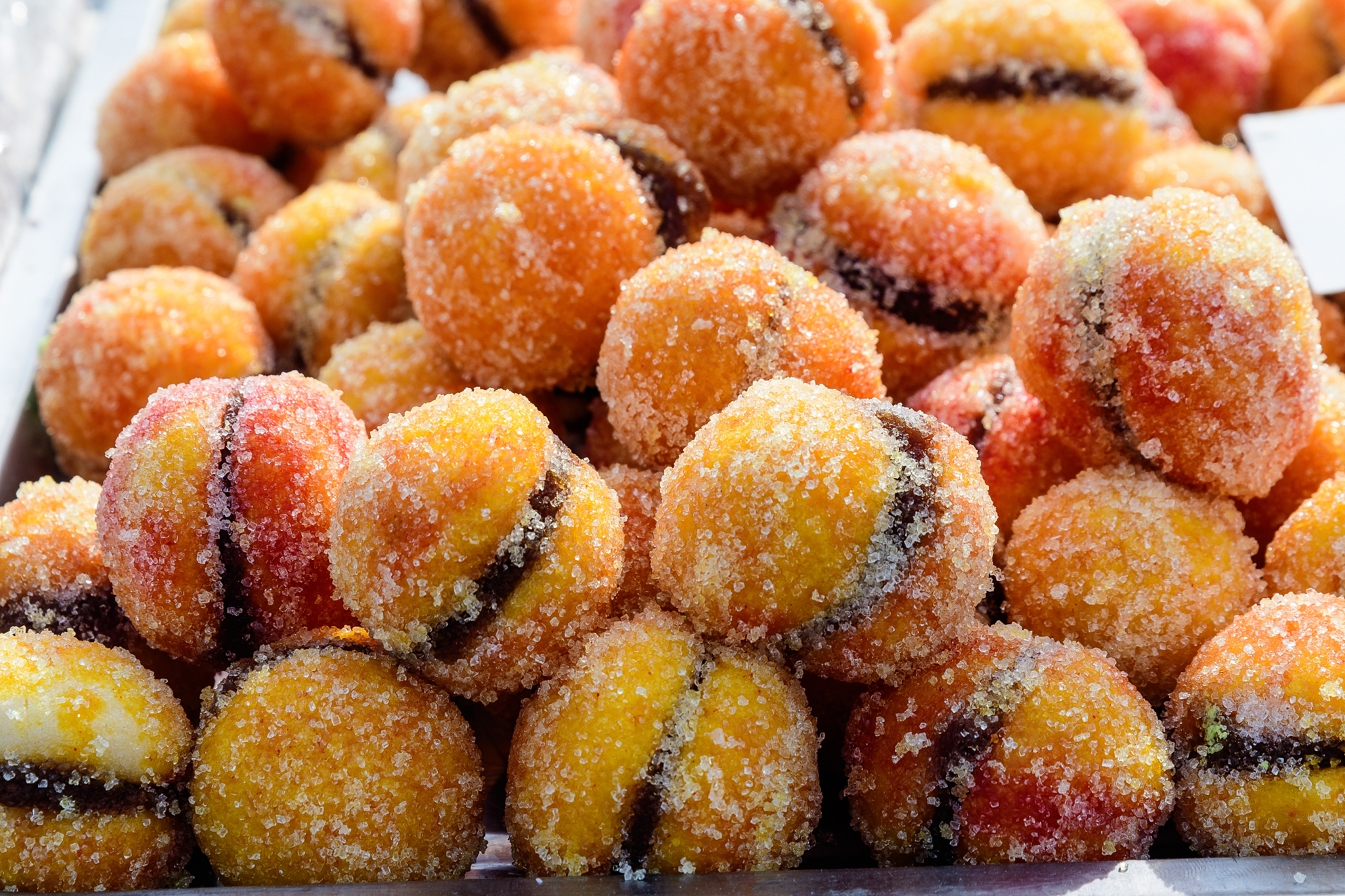 large portion of freshly cooked orange peach cakes in display on