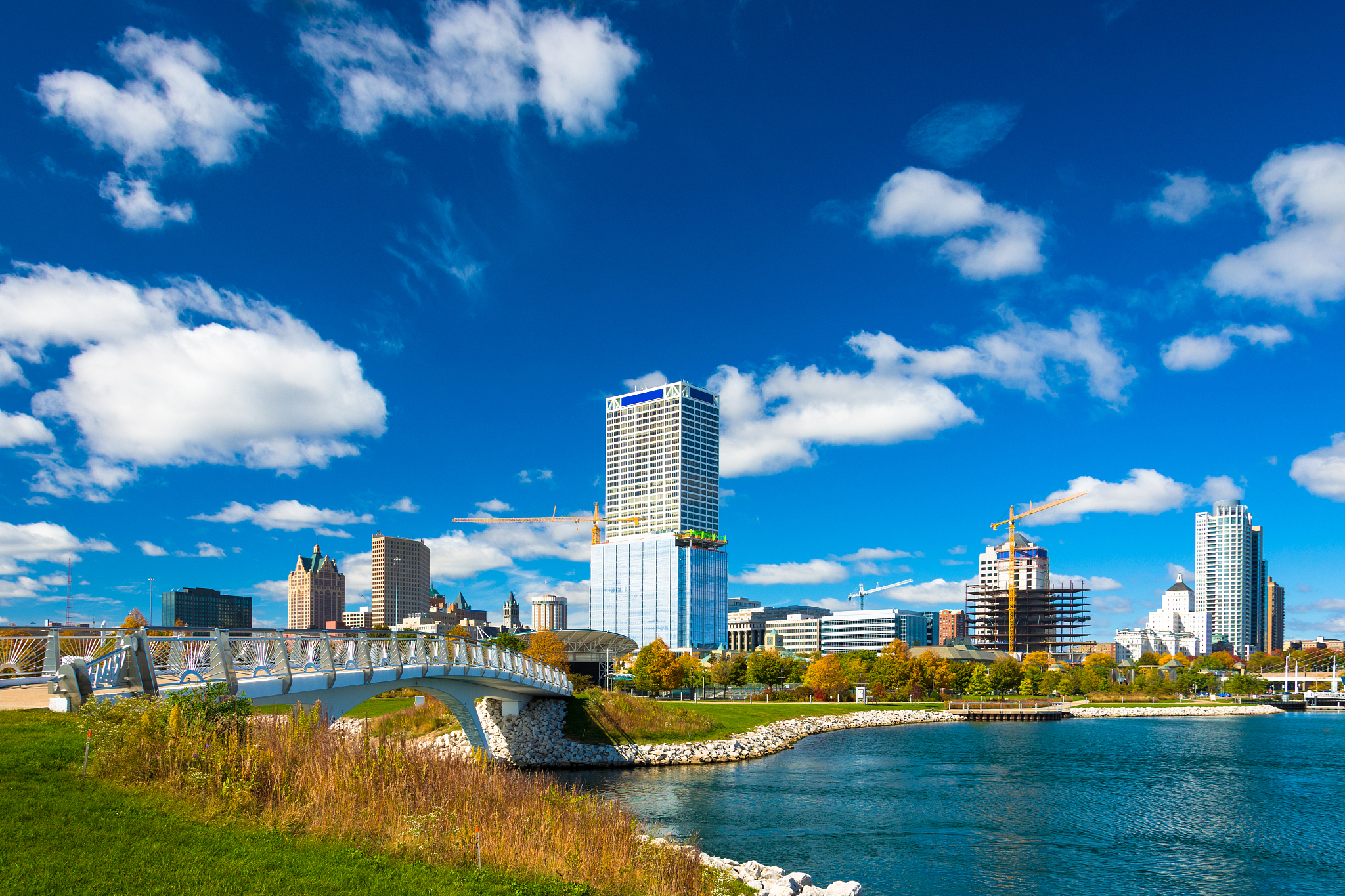 milwaukee skyline with dramatic clouds, park, bridge, and inlet