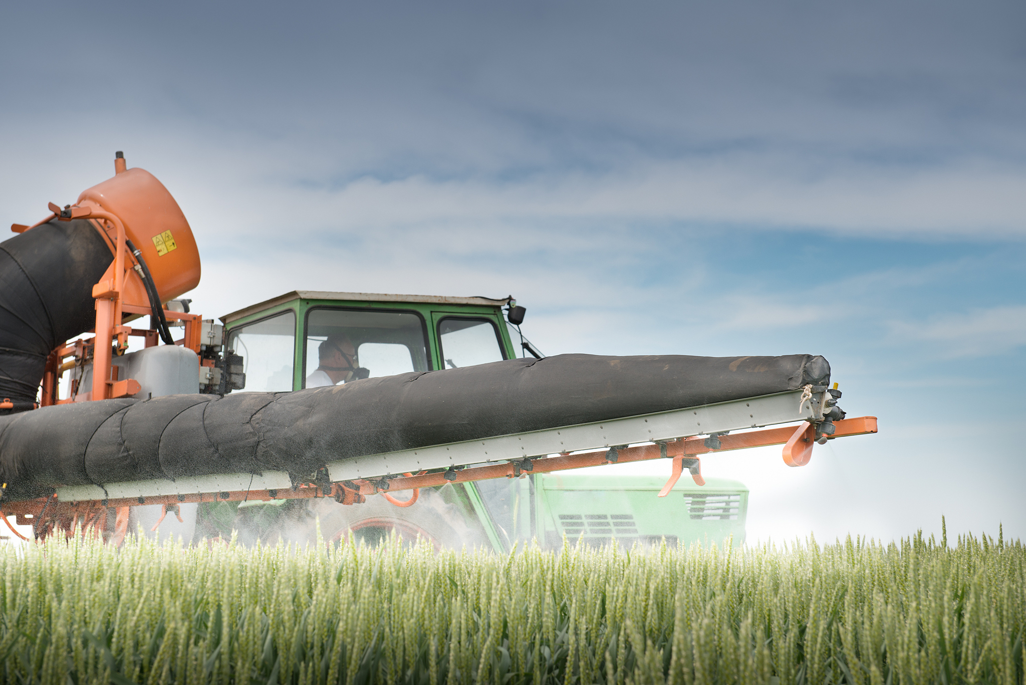 tractor spraying on the field