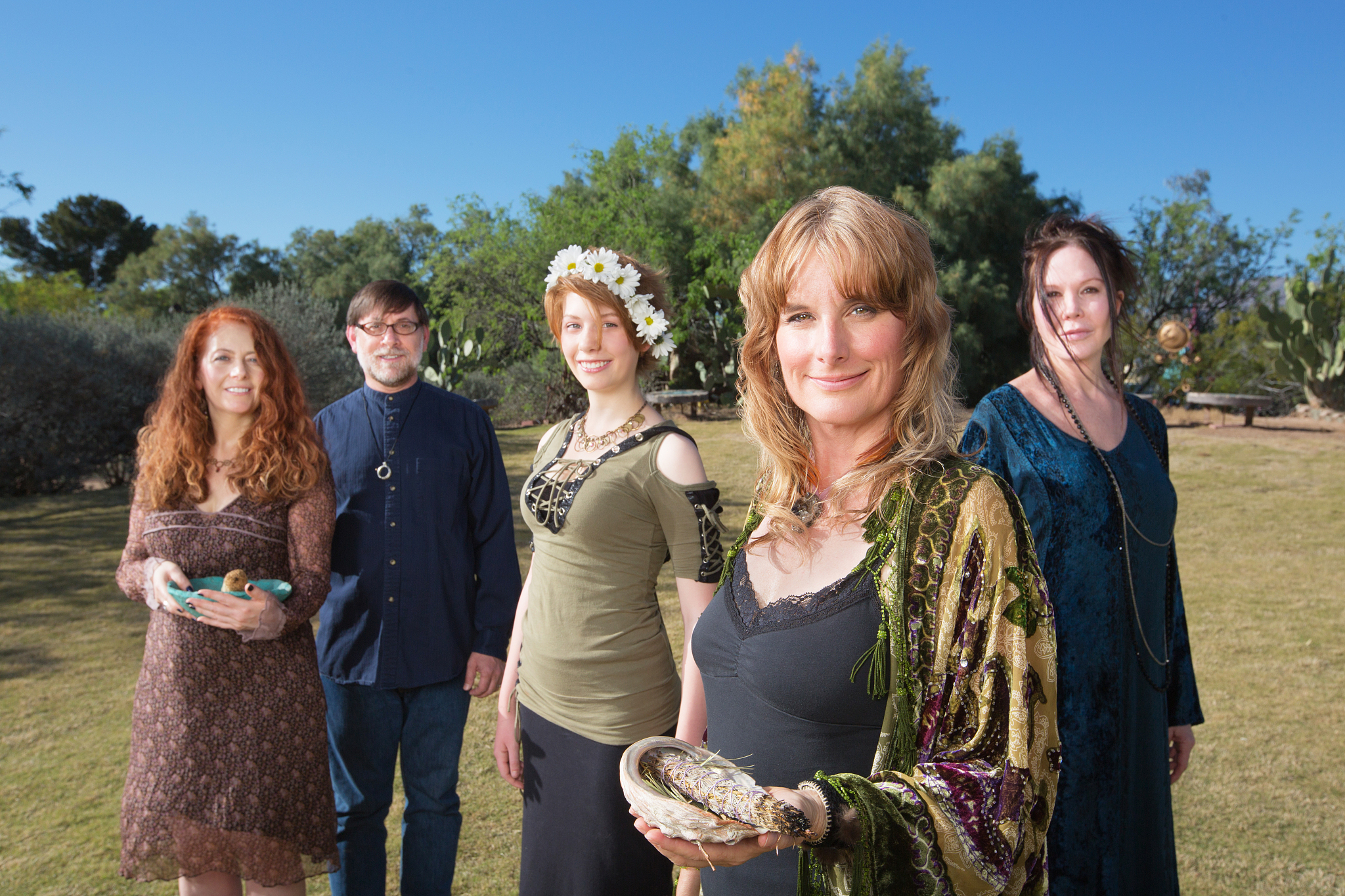 polytheists outdoors with smudge sticks