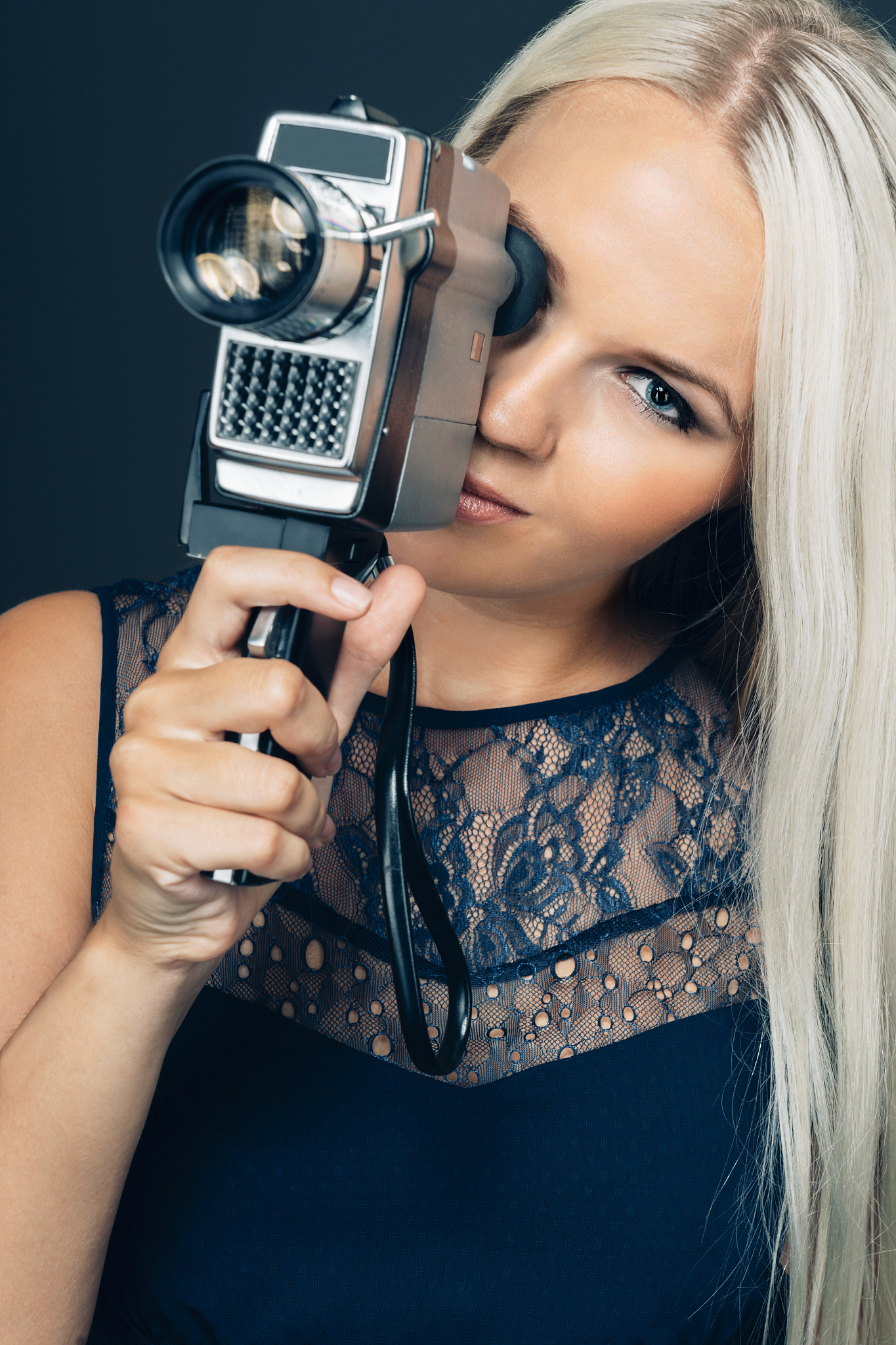 woman records a movie with old retro 8mm analog camera