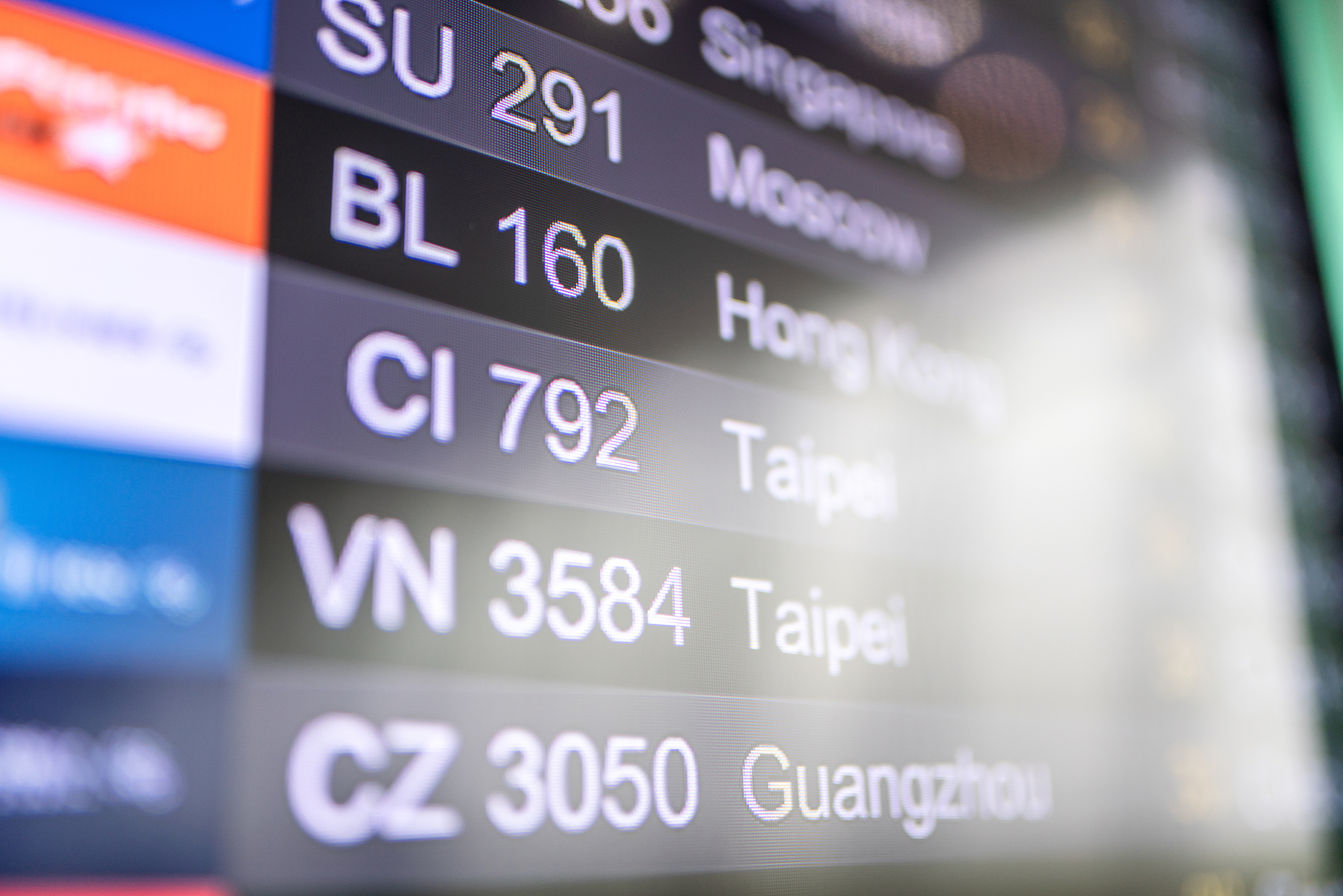 flight numbers and departure status at digital display in airpor