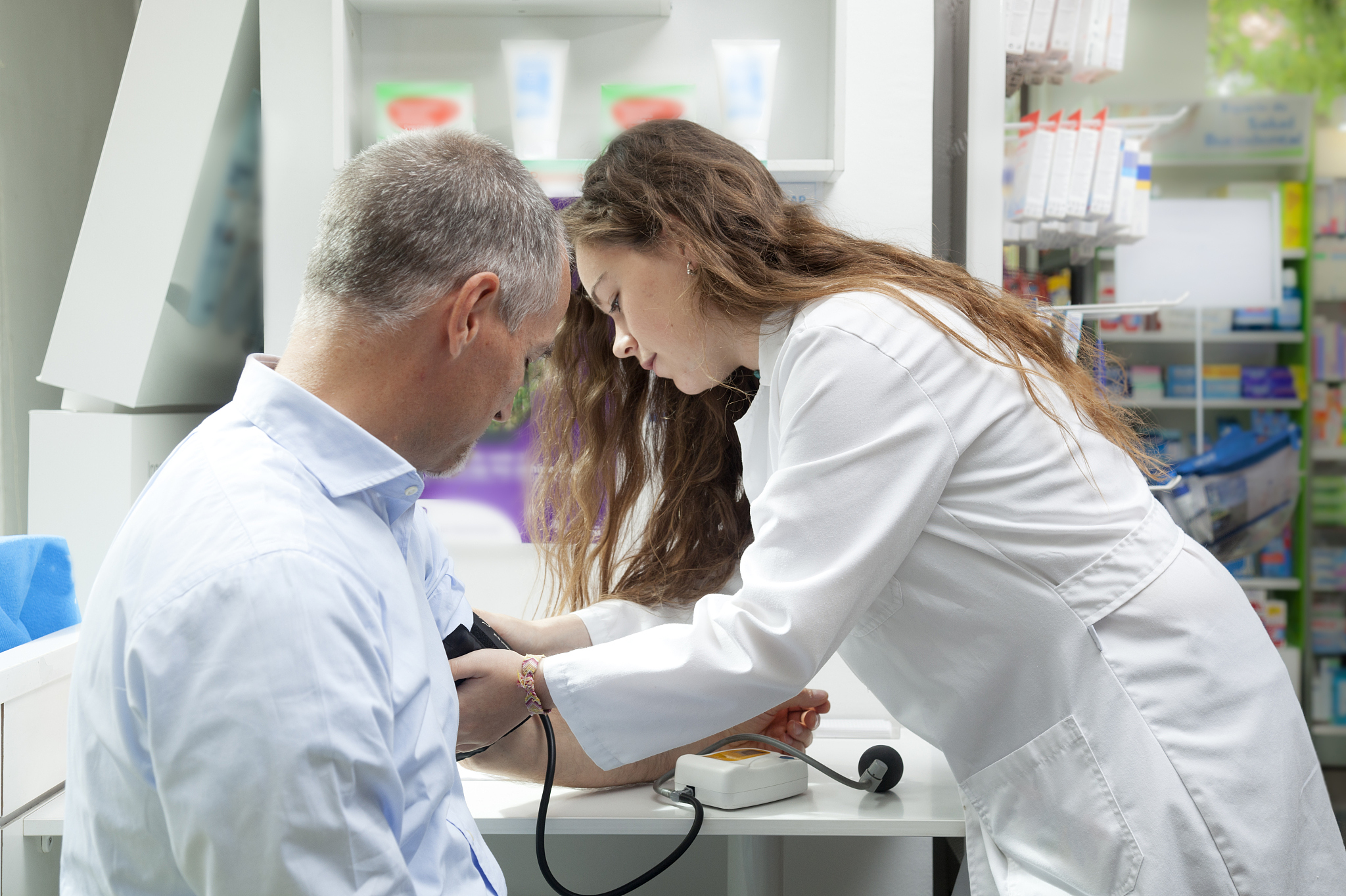 girl taking blood pressure to mature man