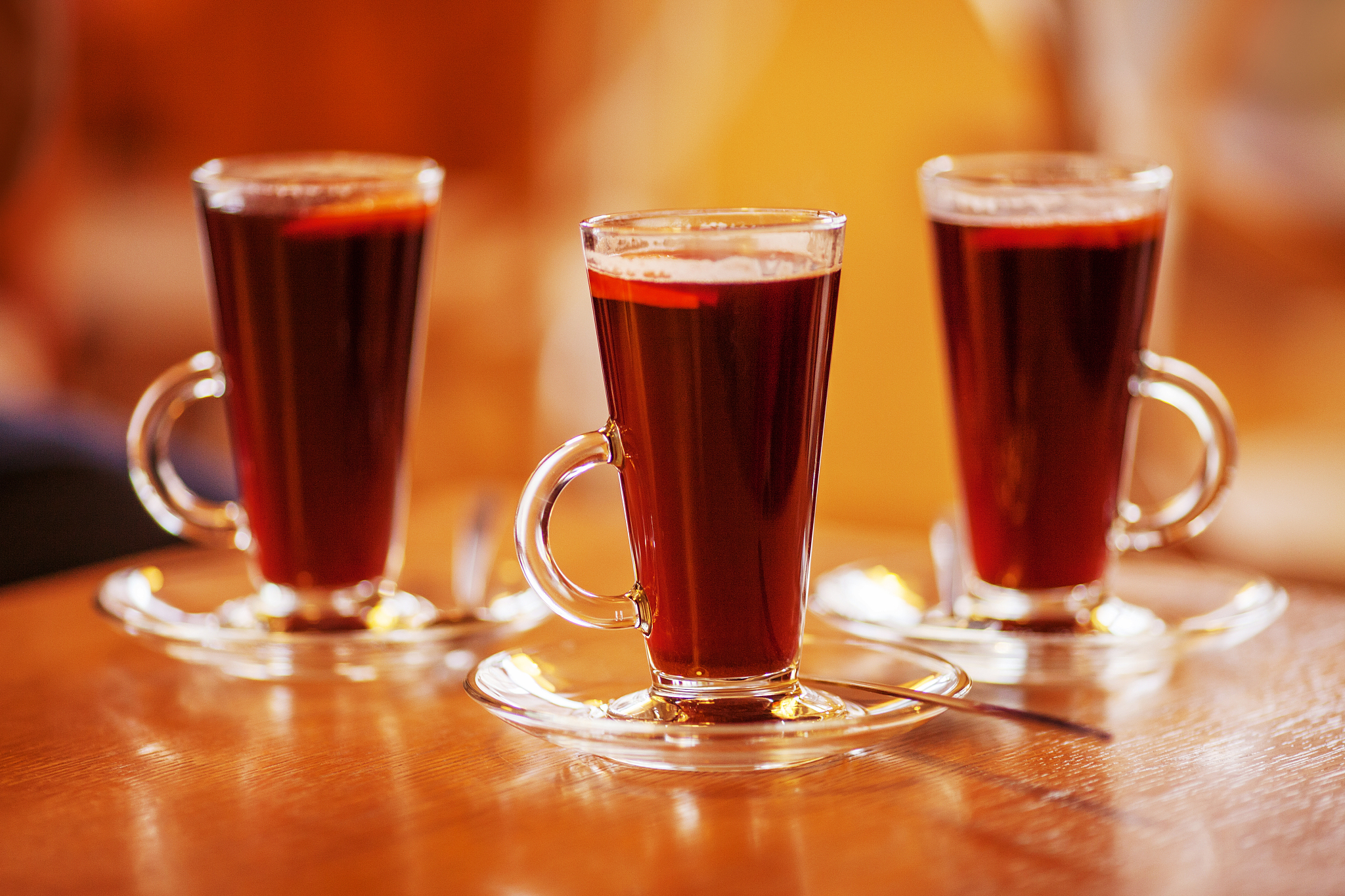 three glasses of red hot drink. mulled wine or tea. warm atmosph