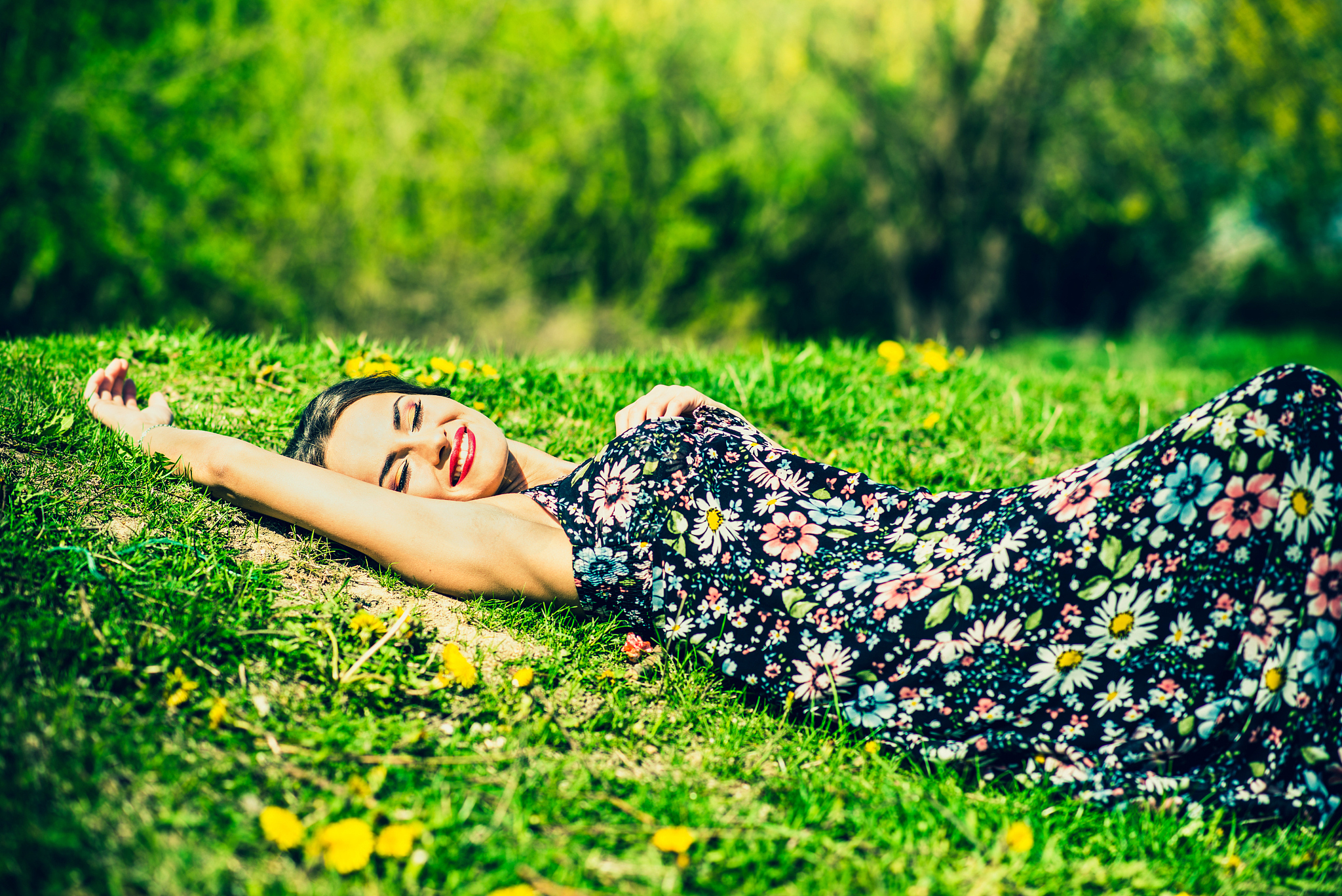 pretty brunette woman relaxing on te grass in the park