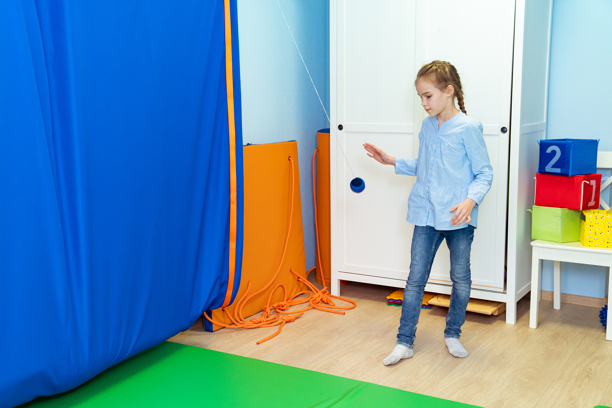 girl playing with pendulin sensory integration