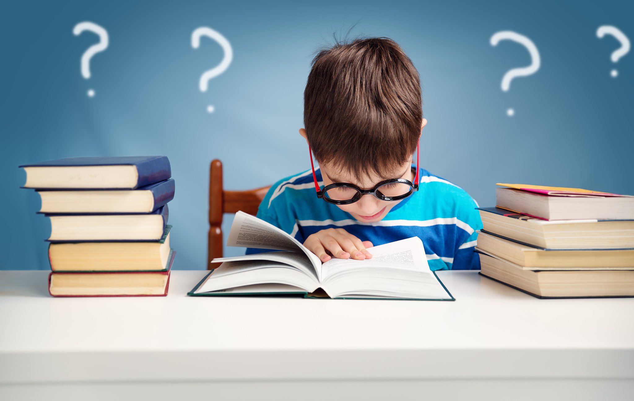 seven years old child reading a book