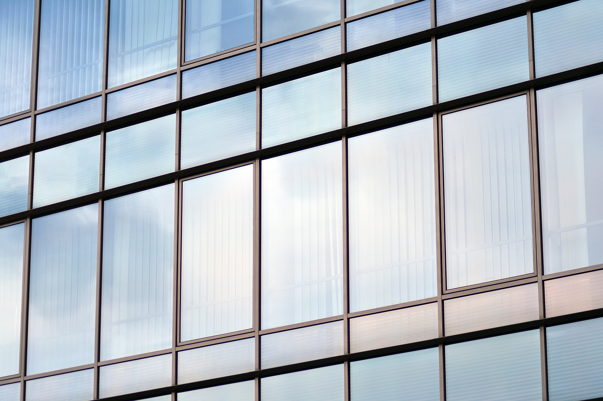 modern building with reflected sky and cloud in glass window