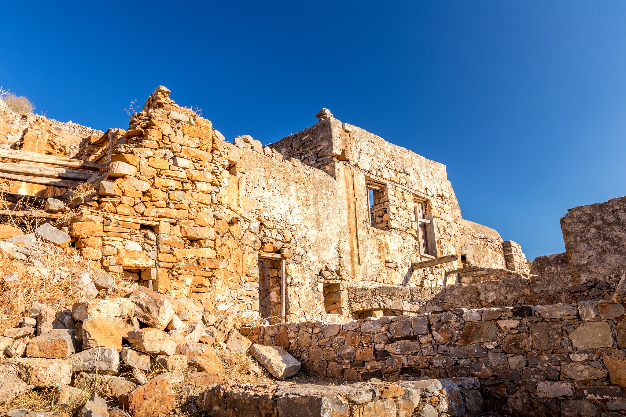 old buildings and ruins of spinalonga on a sunny day.