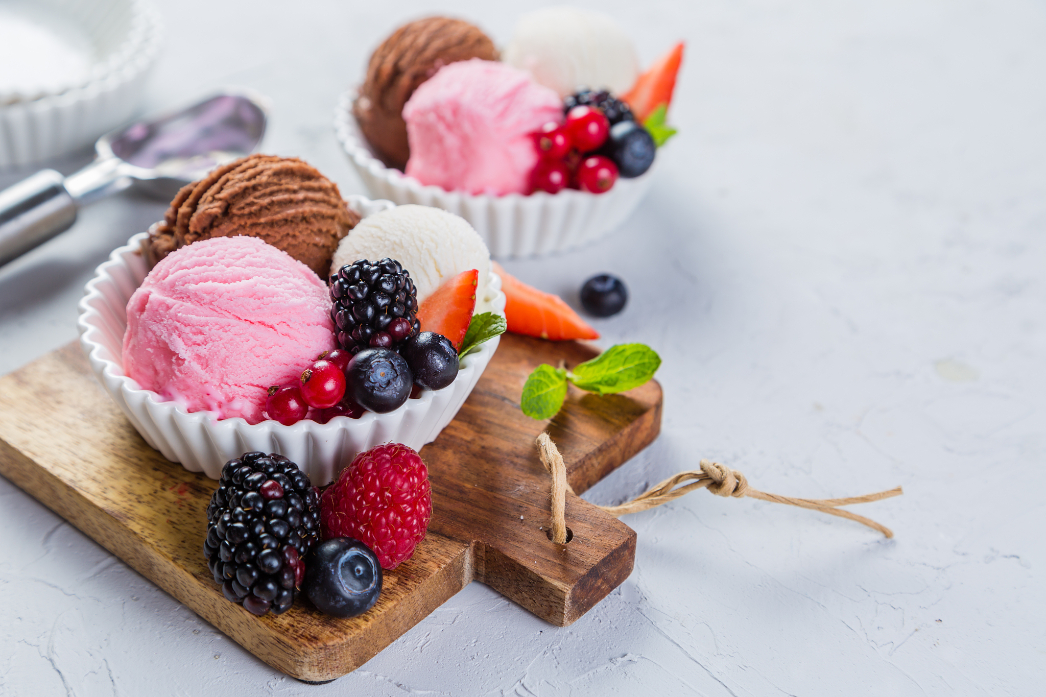 selection of colorful ice cream scoops in white bowls