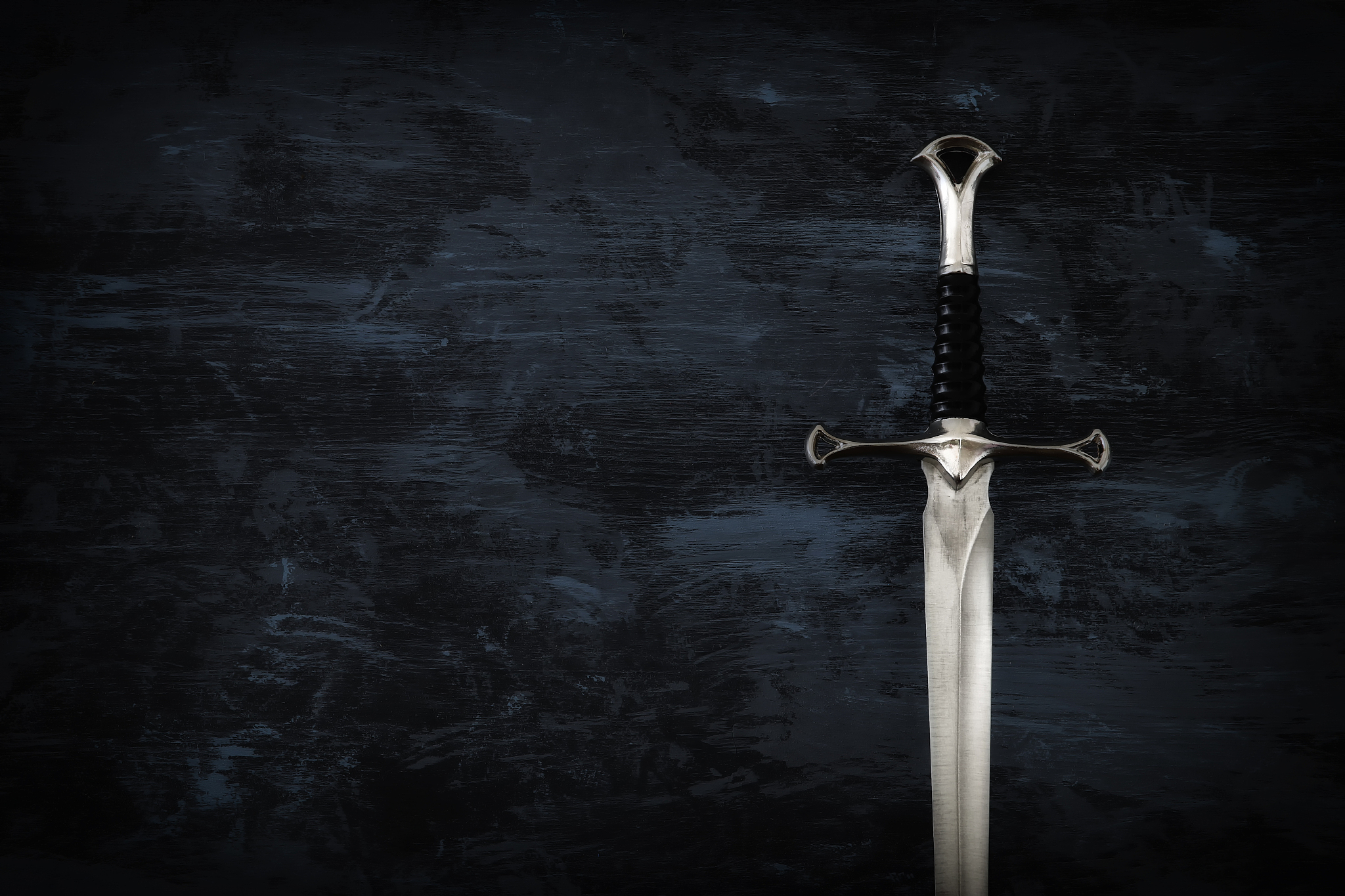 low key image of silver sword. fantasy medieval period.
