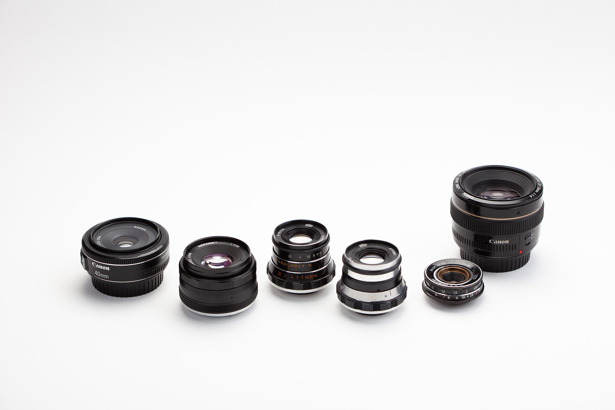 camera lenses over white background