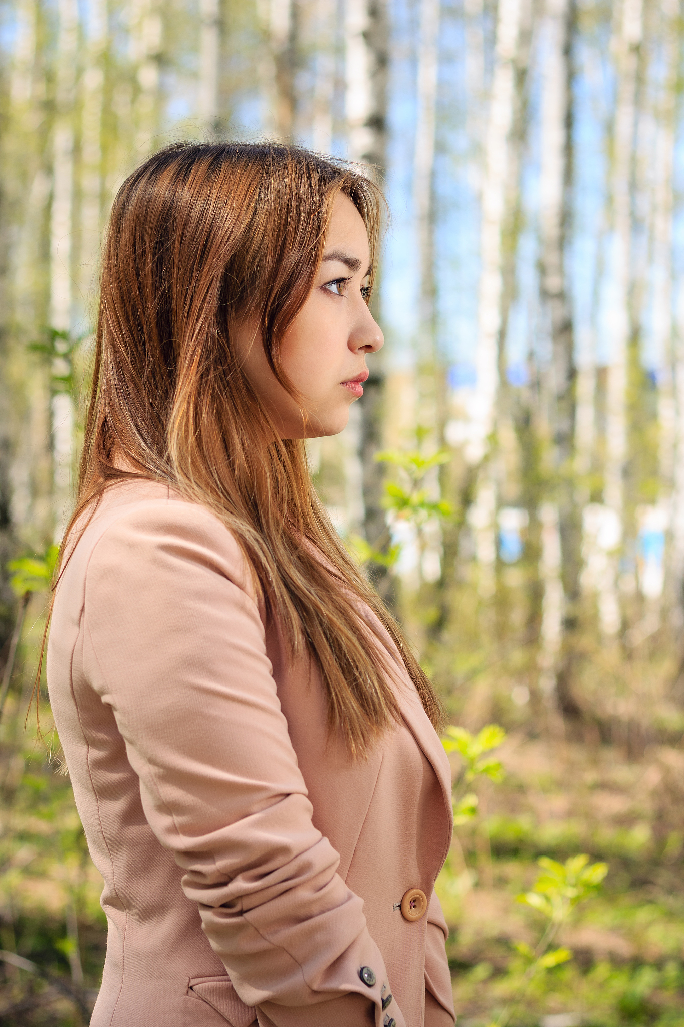 portrait of a beautiful girl in a birch grove (in profile)