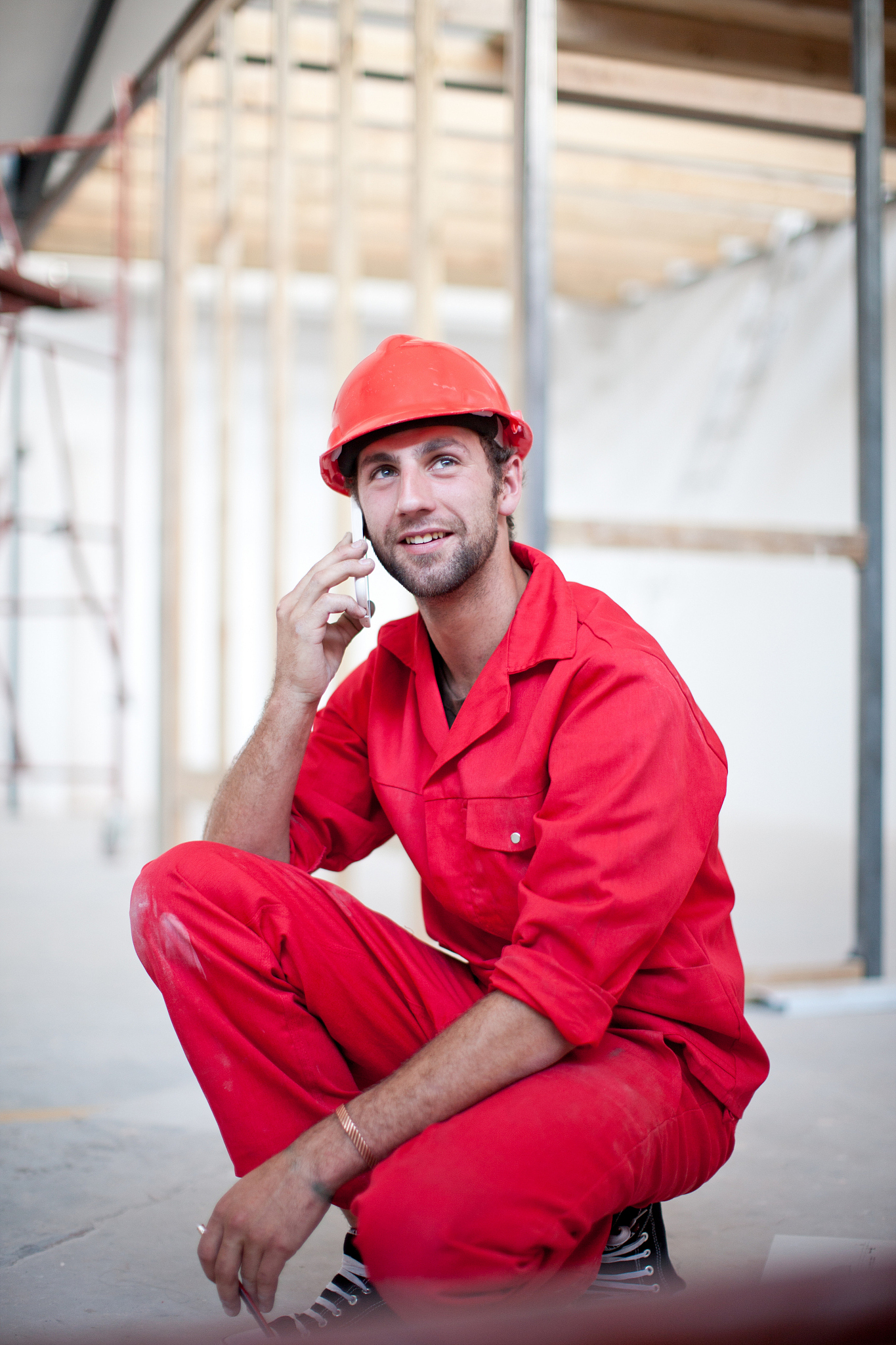 builder on construction site on mobile phone
