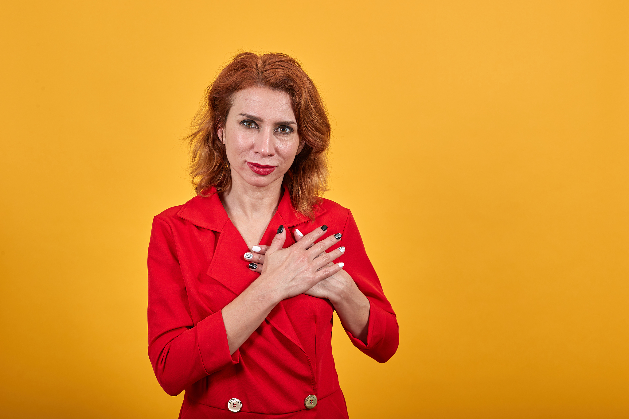 calm attractive young woman keeping palms crossed on chest