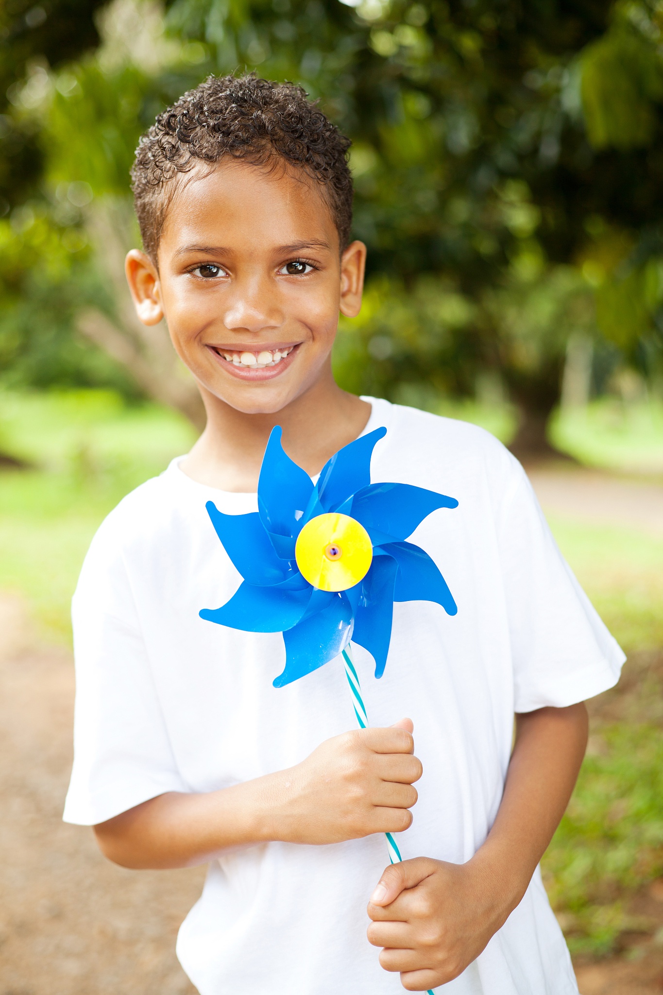 little boy holding a pinwheel