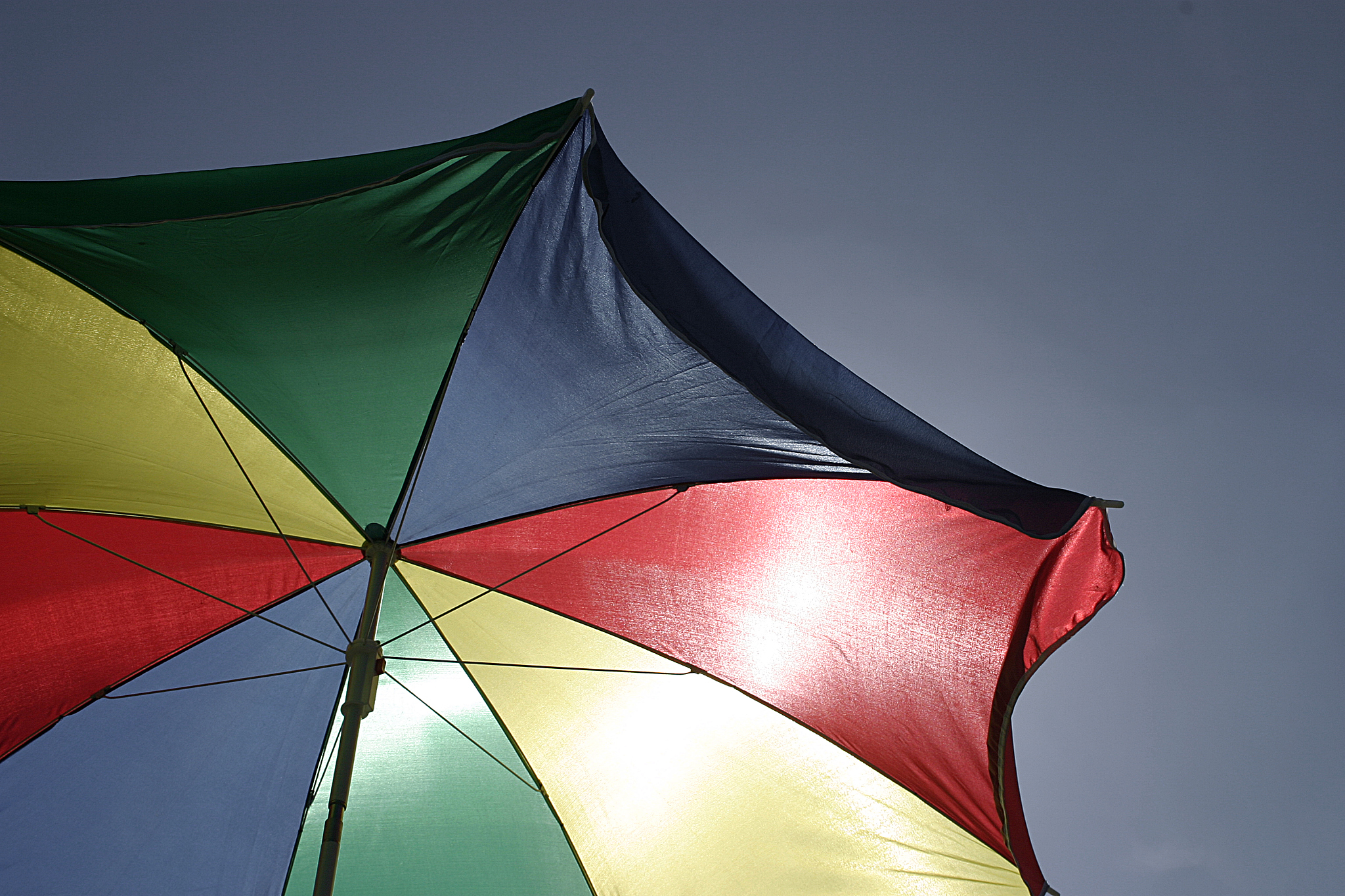 sun shining through beach umbrella