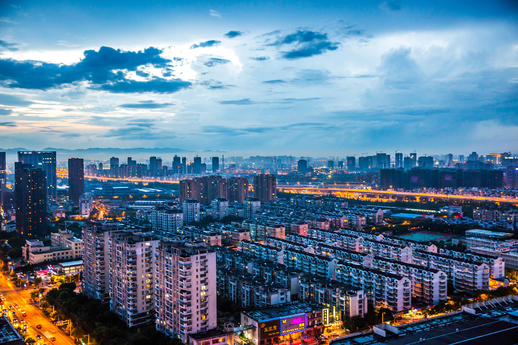 high angle view of illuminated cityscape against sky