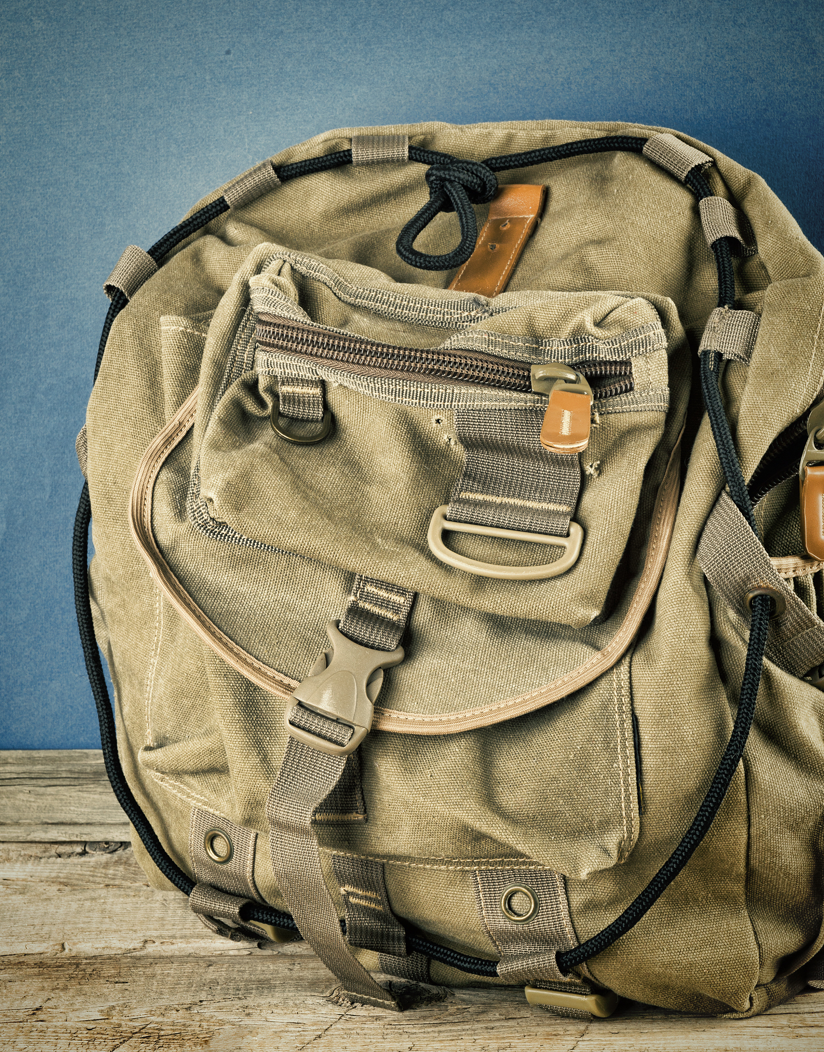 old travel backpack on the wooden floor. toned