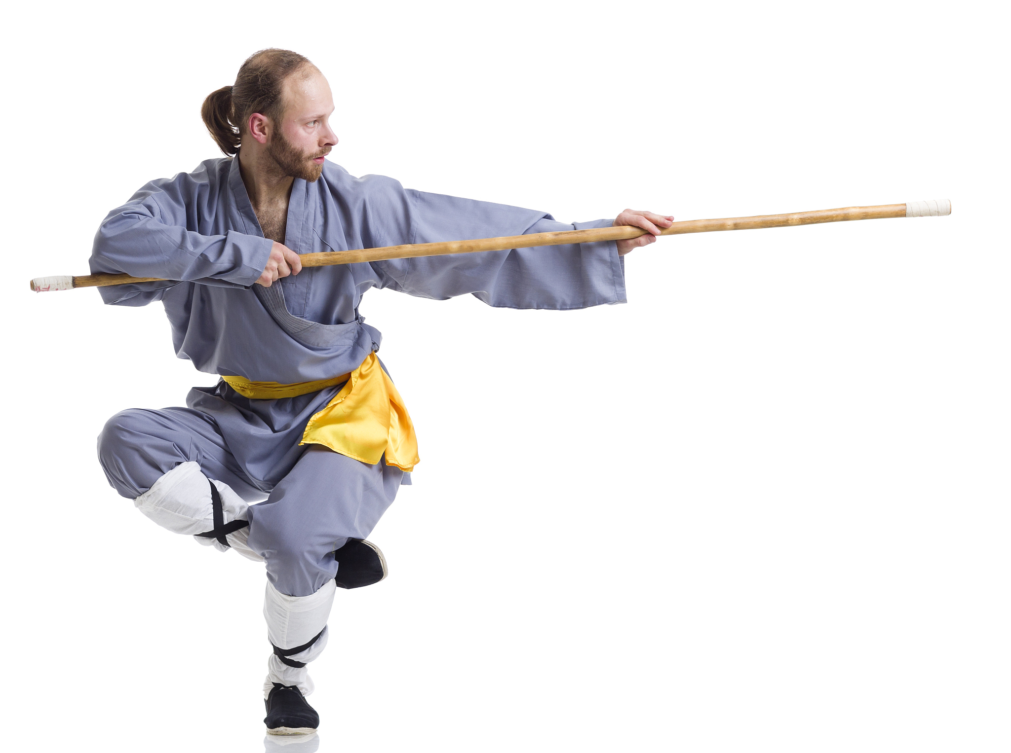 kung fu fighting position with wushu cudgel isolated on white