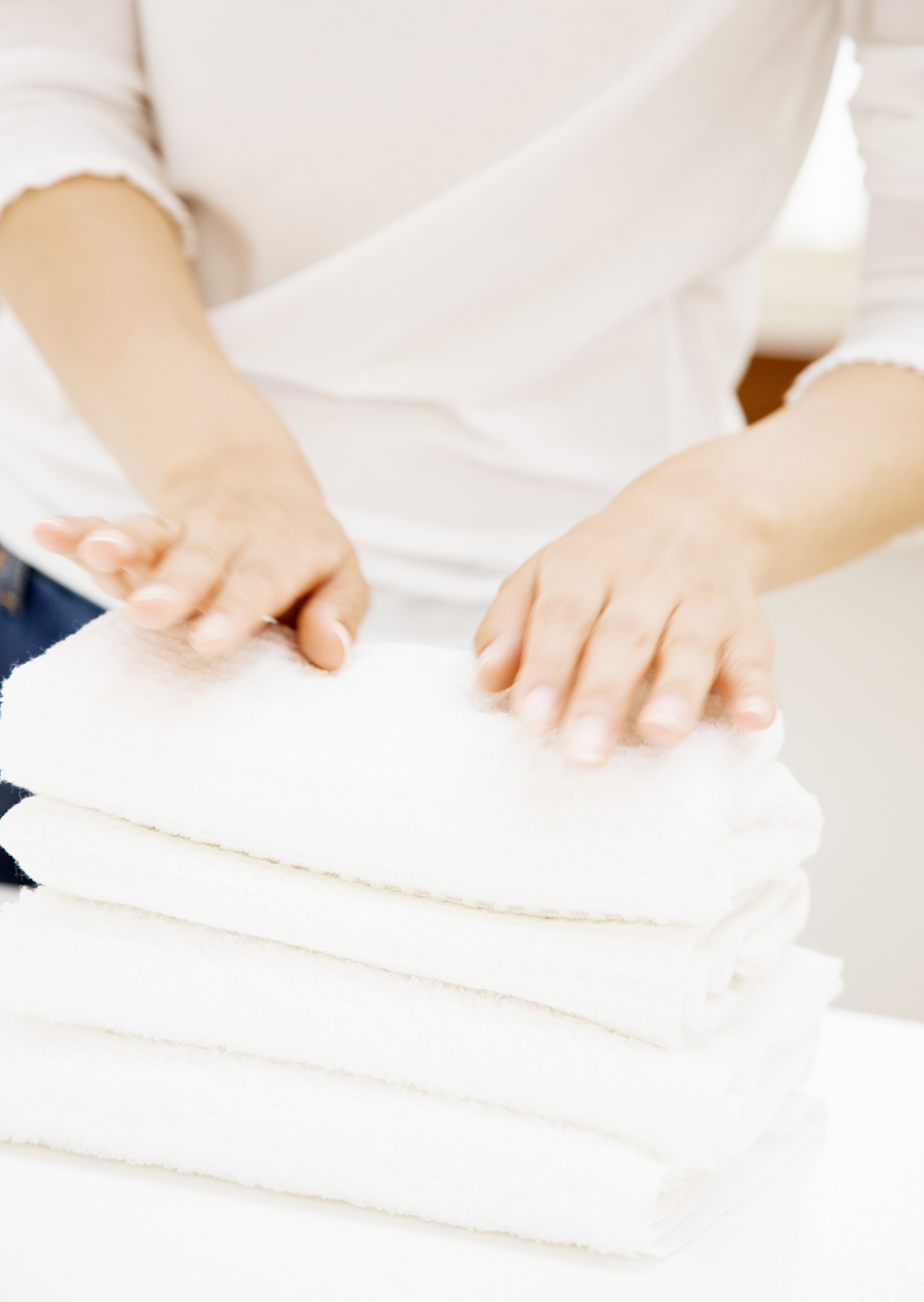 woman's hands of folding towel