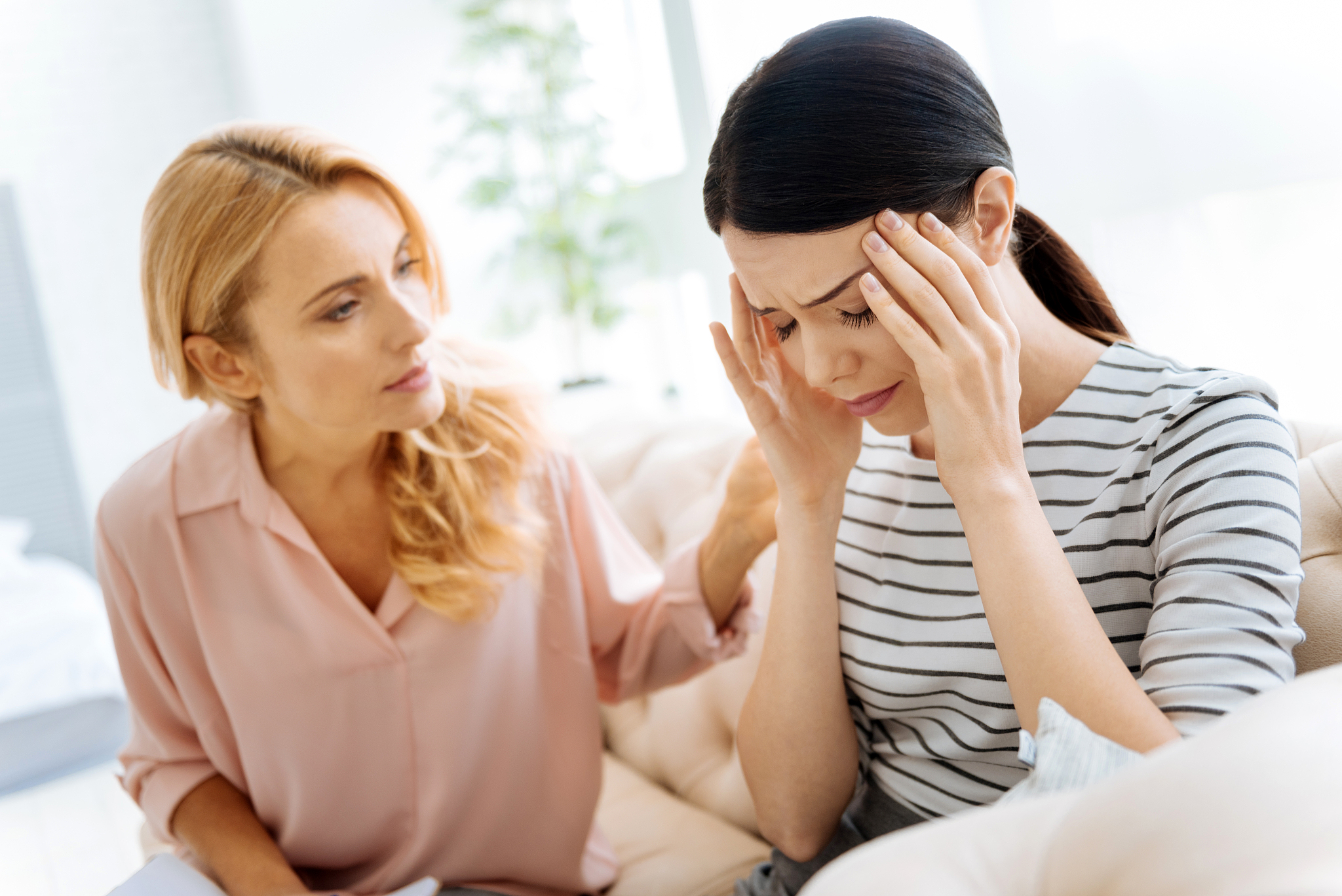 upset young woman holding her head down