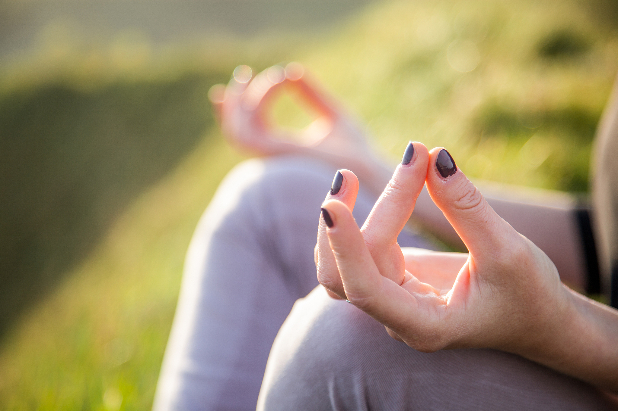 woman doing yoga in beautiful nature background at sunset or sun