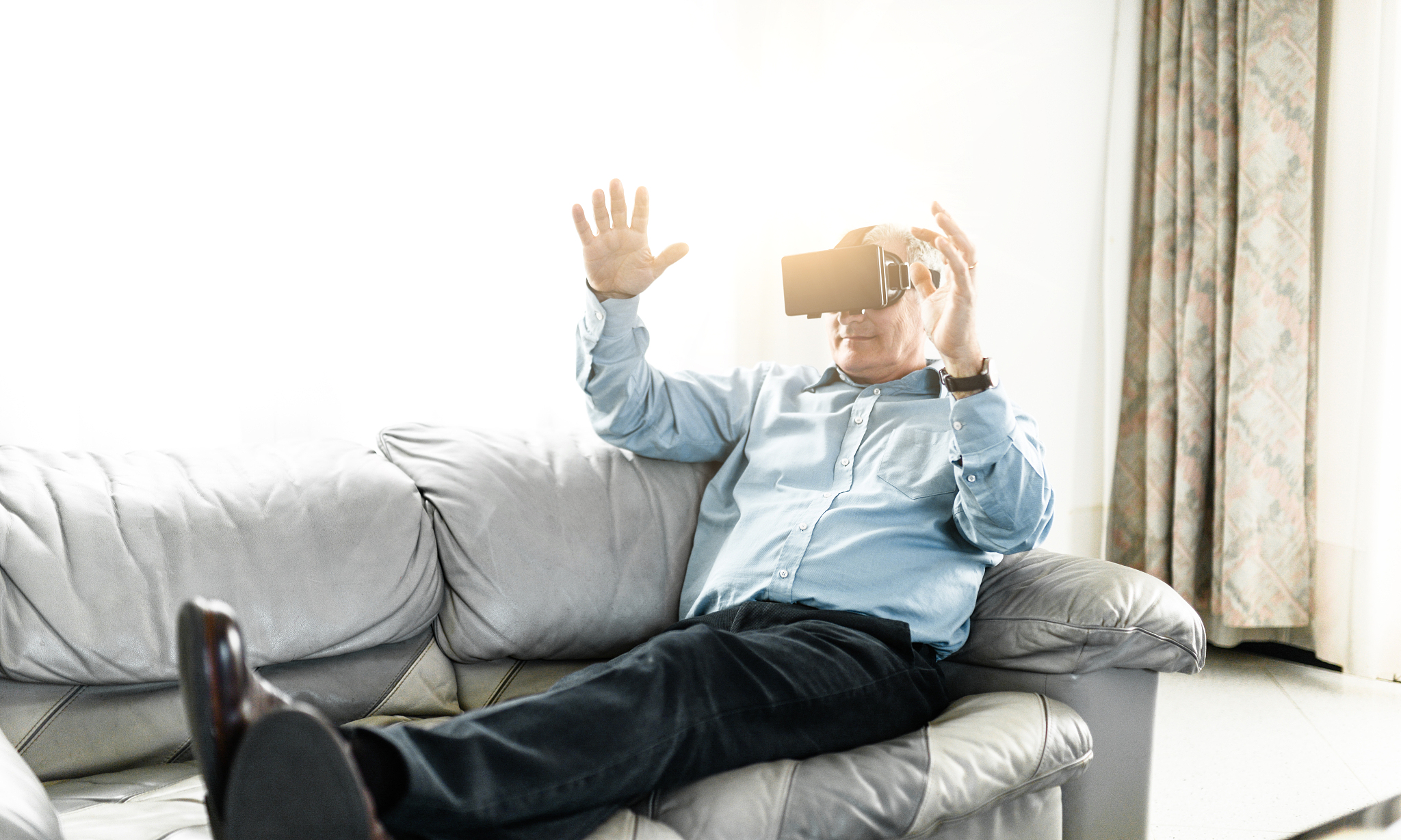 businessman watching a movie on the couch