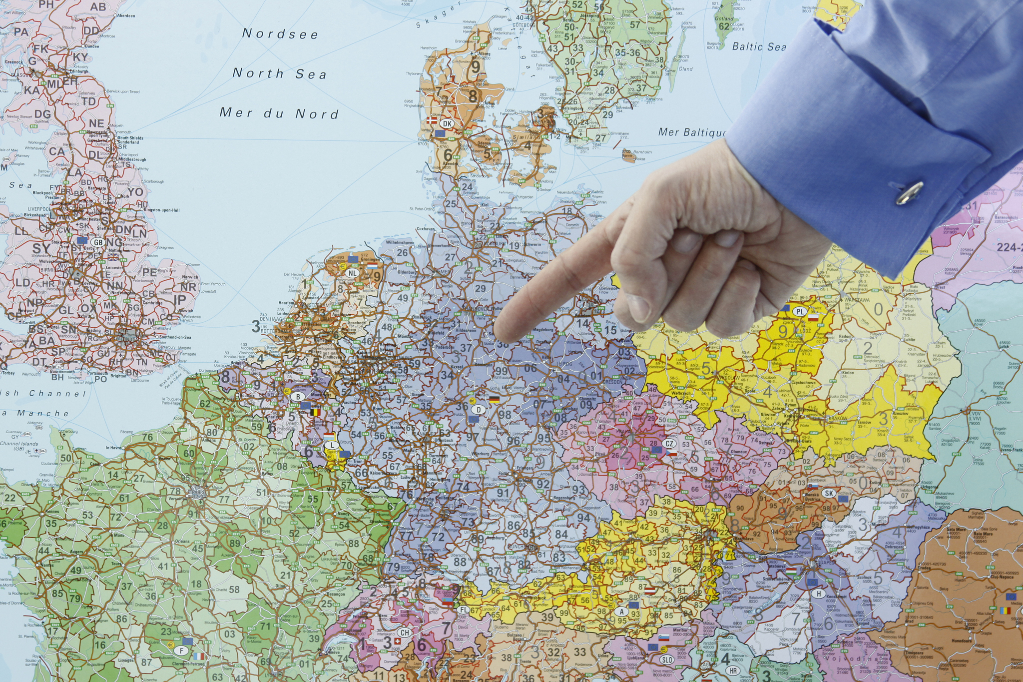 businessman is pointing to germany on a map xl