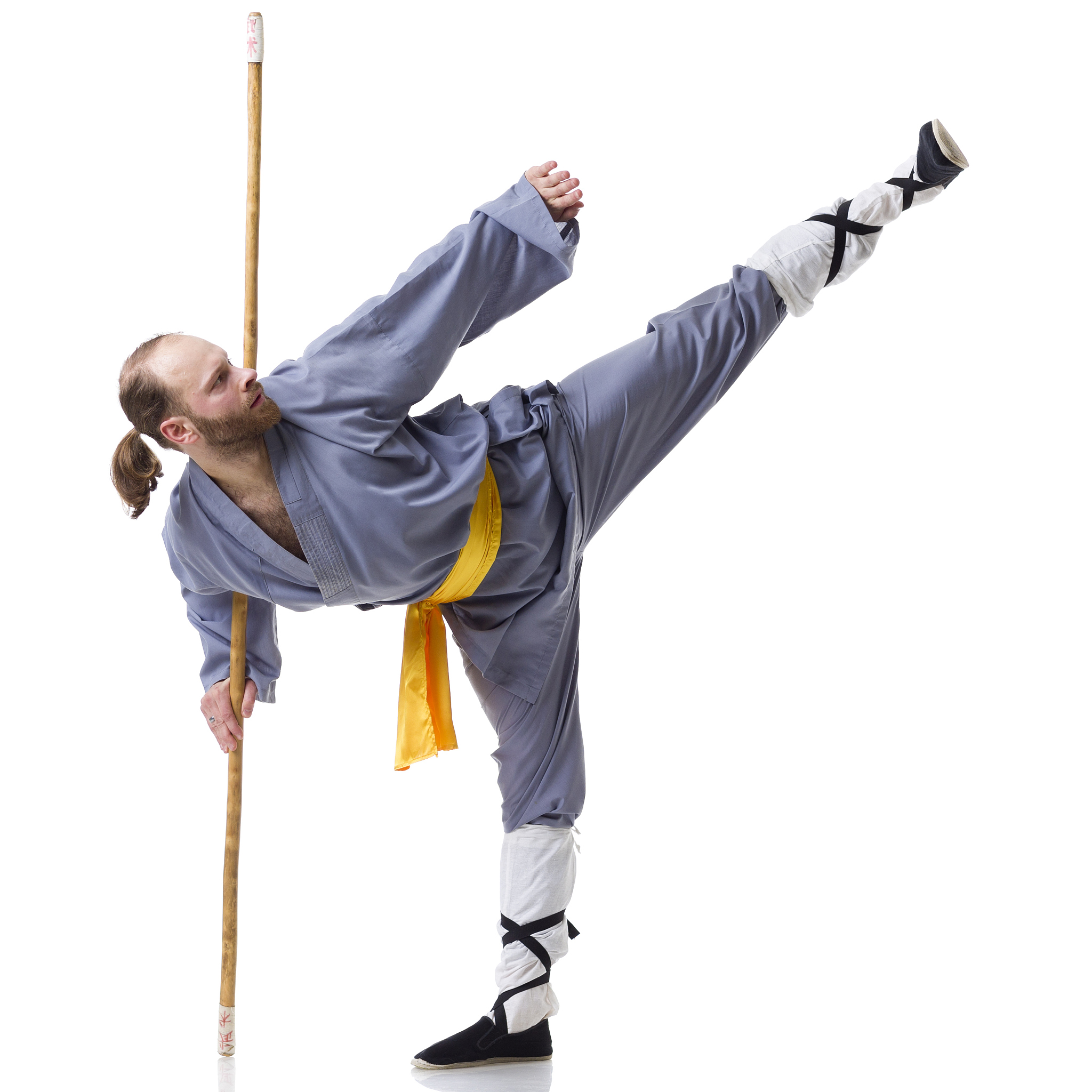 kung fu fighting position with wushu cudgel isolated on white