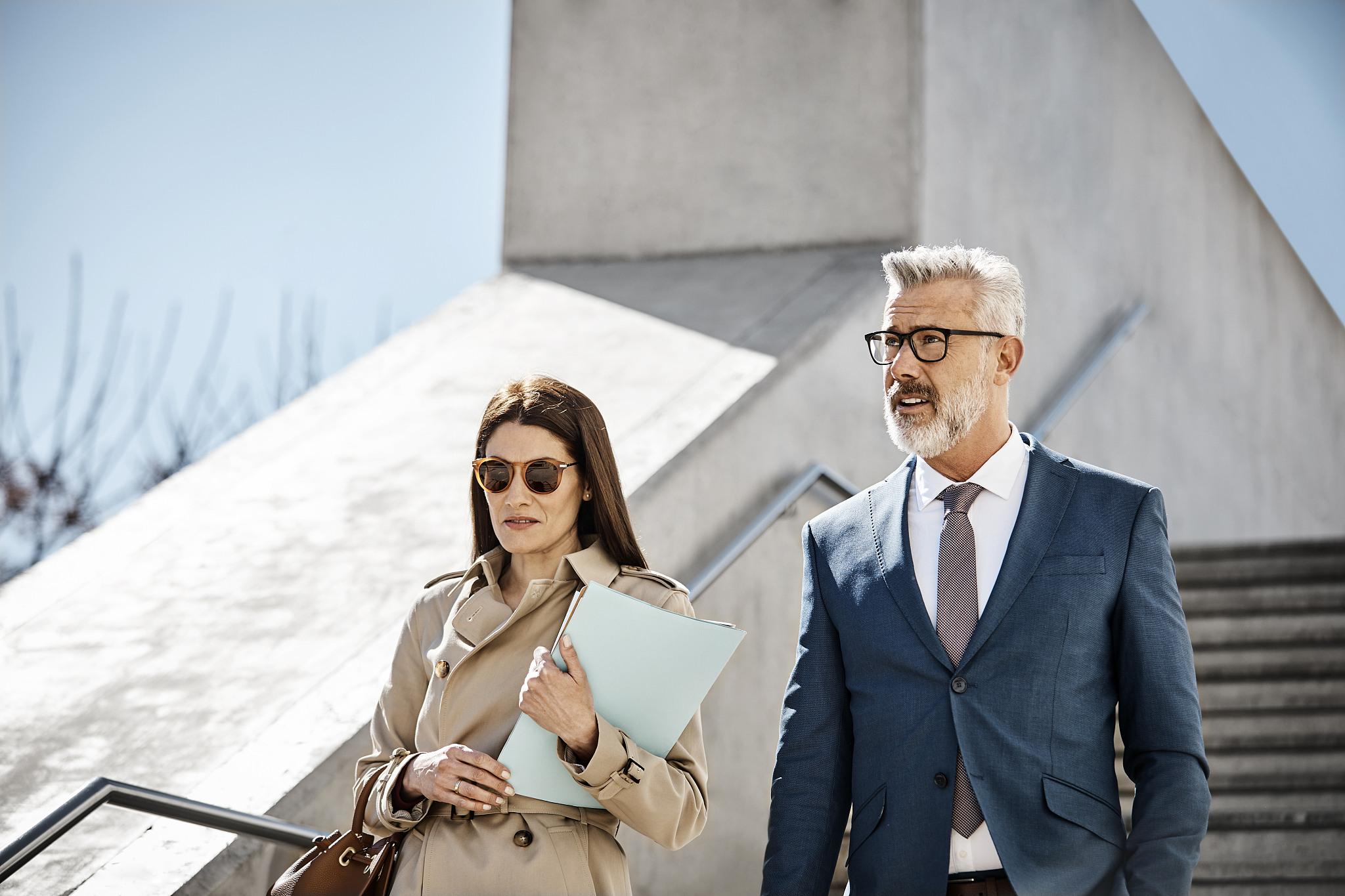 male and female colleagues on stairs in city'n