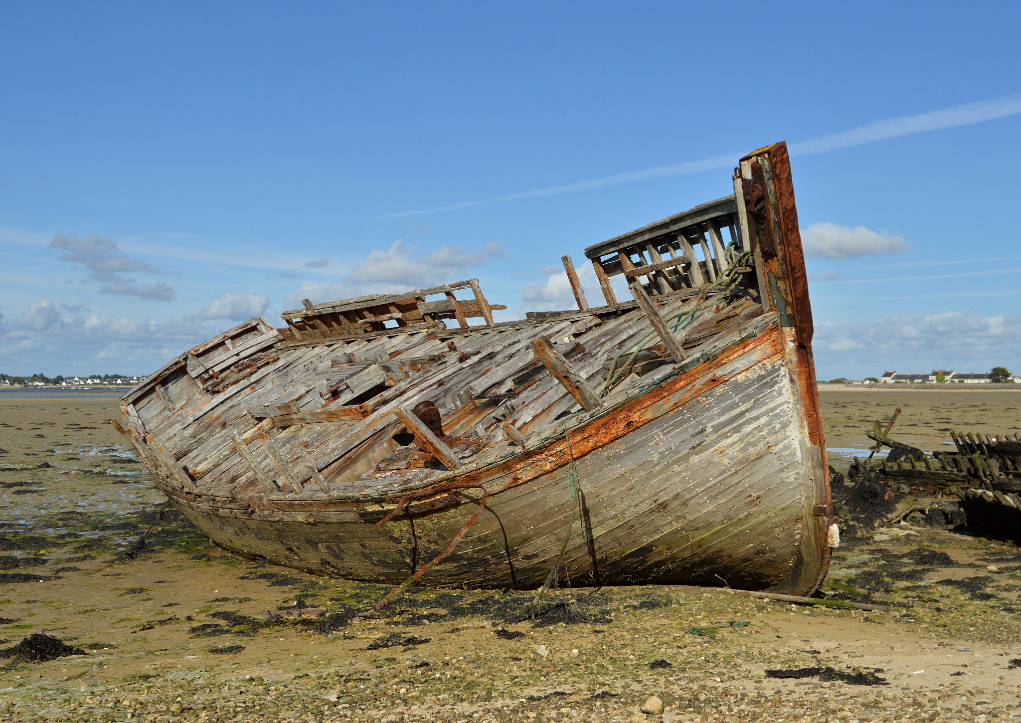 abandoned boat against sky at beach
