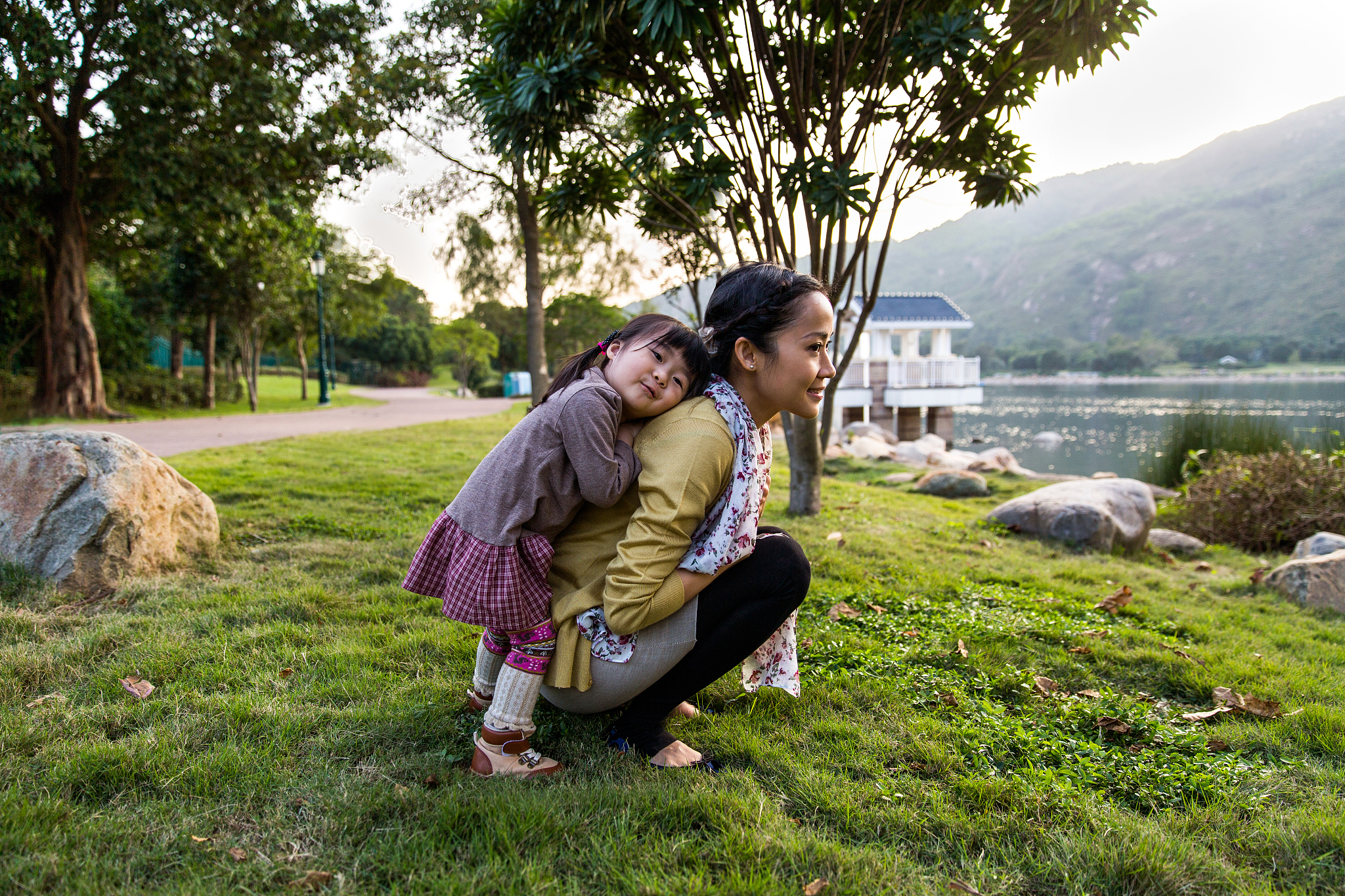 toddler girl resting her head on mom's back