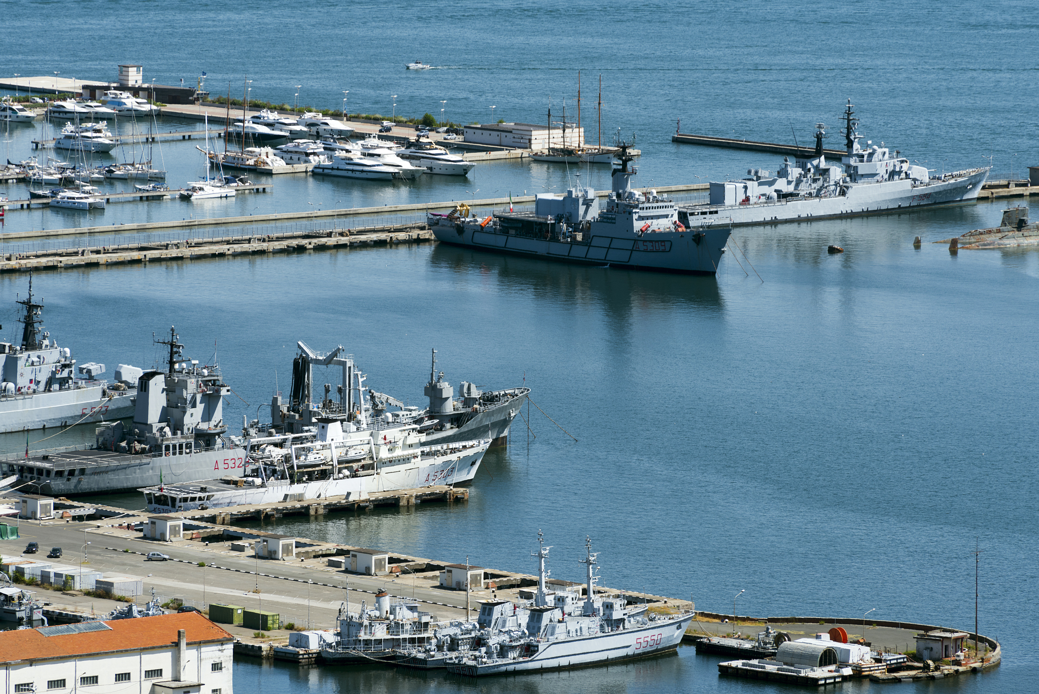 view of the military, commercial dock and ships with mountains o