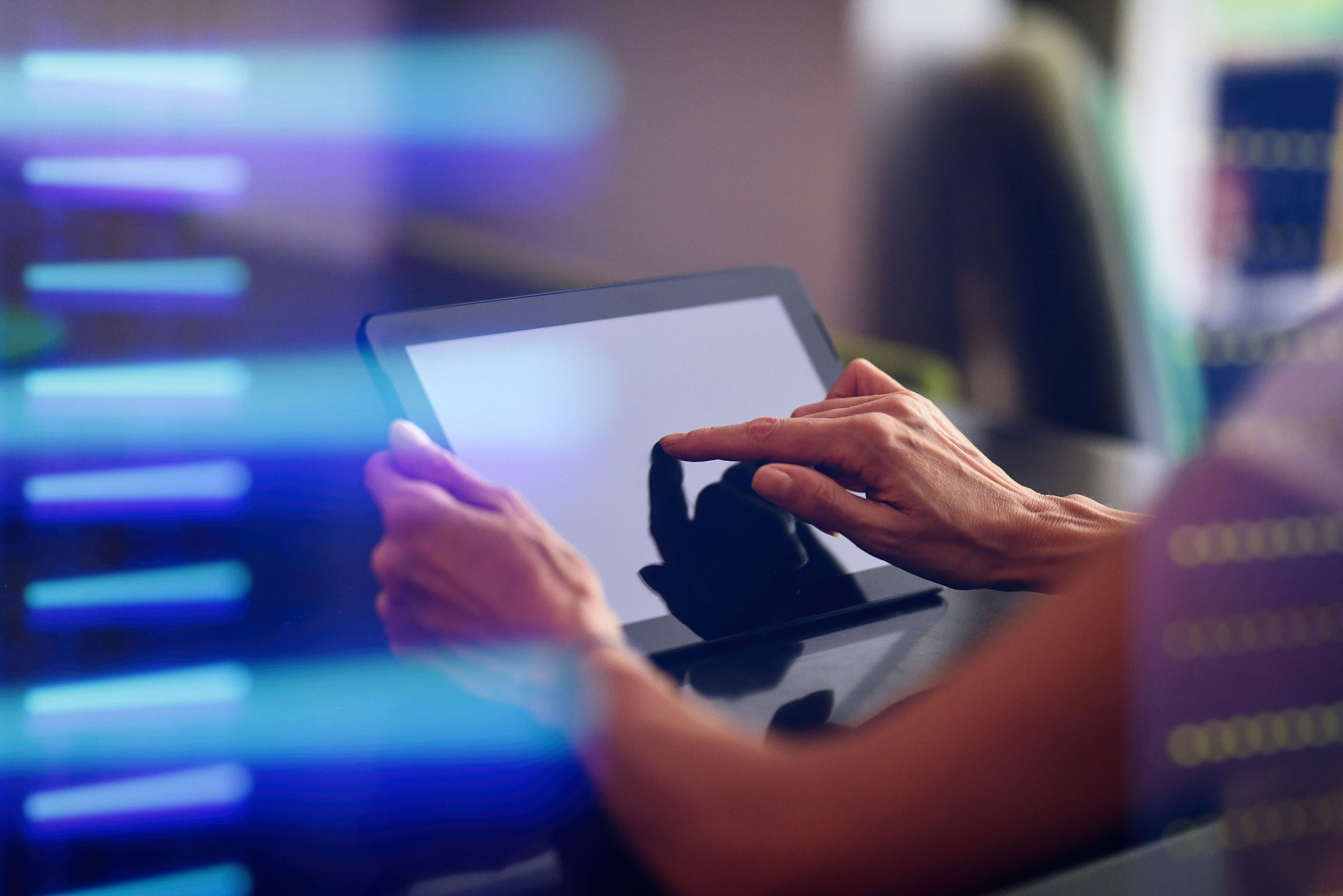 woman's hand using digital tablet in data center