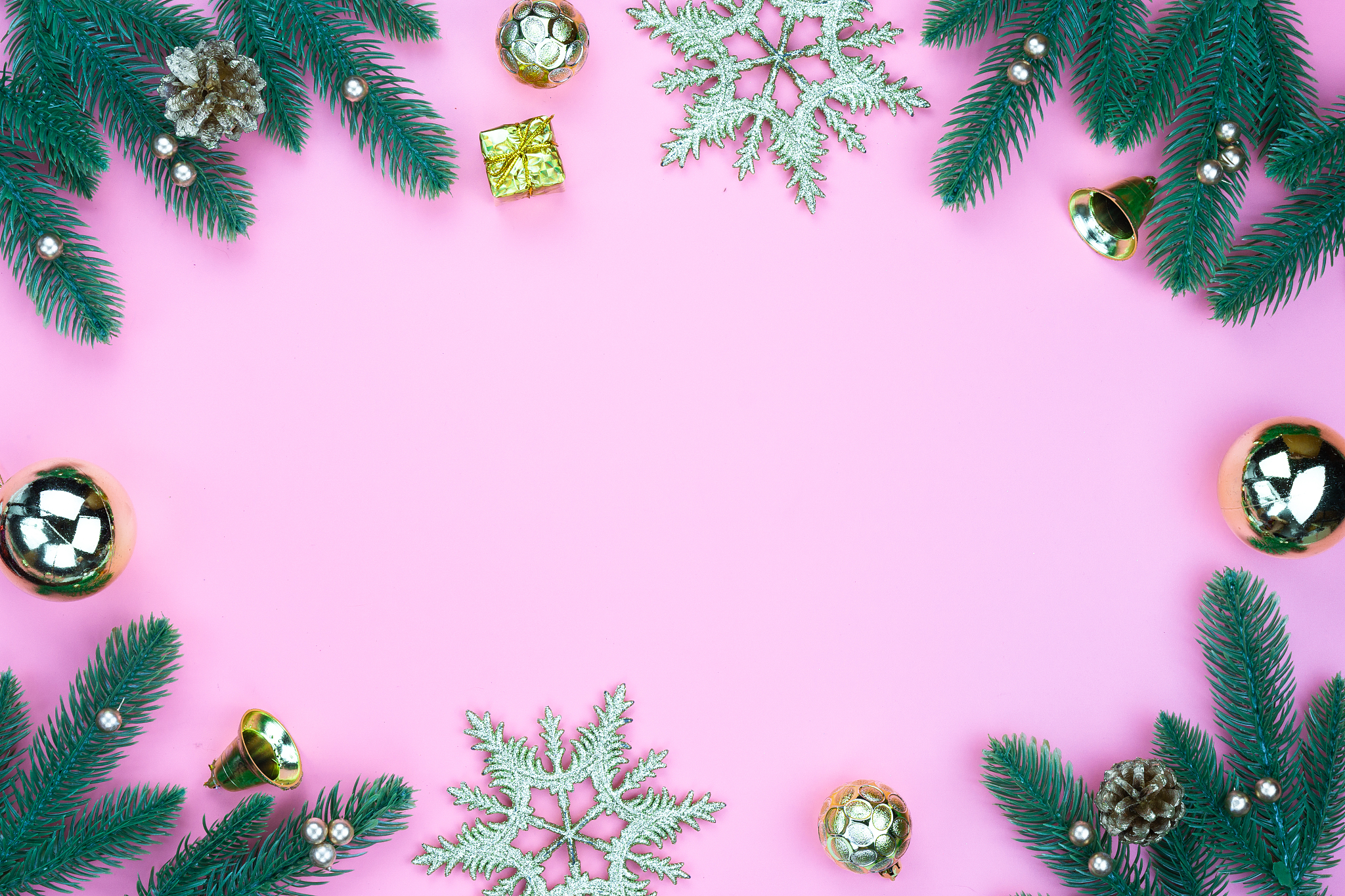 directly above shot of christmas decorations on pink background