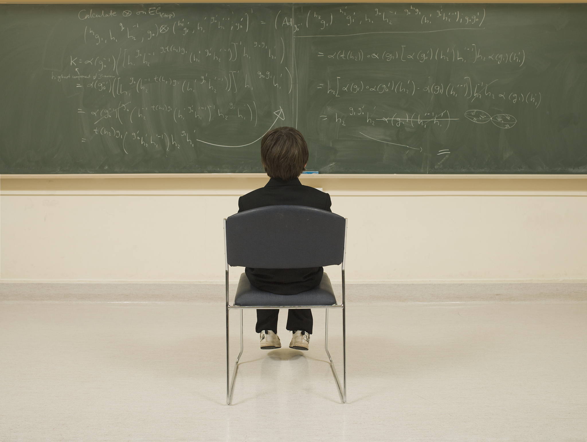 child prodigy looking at blackboard