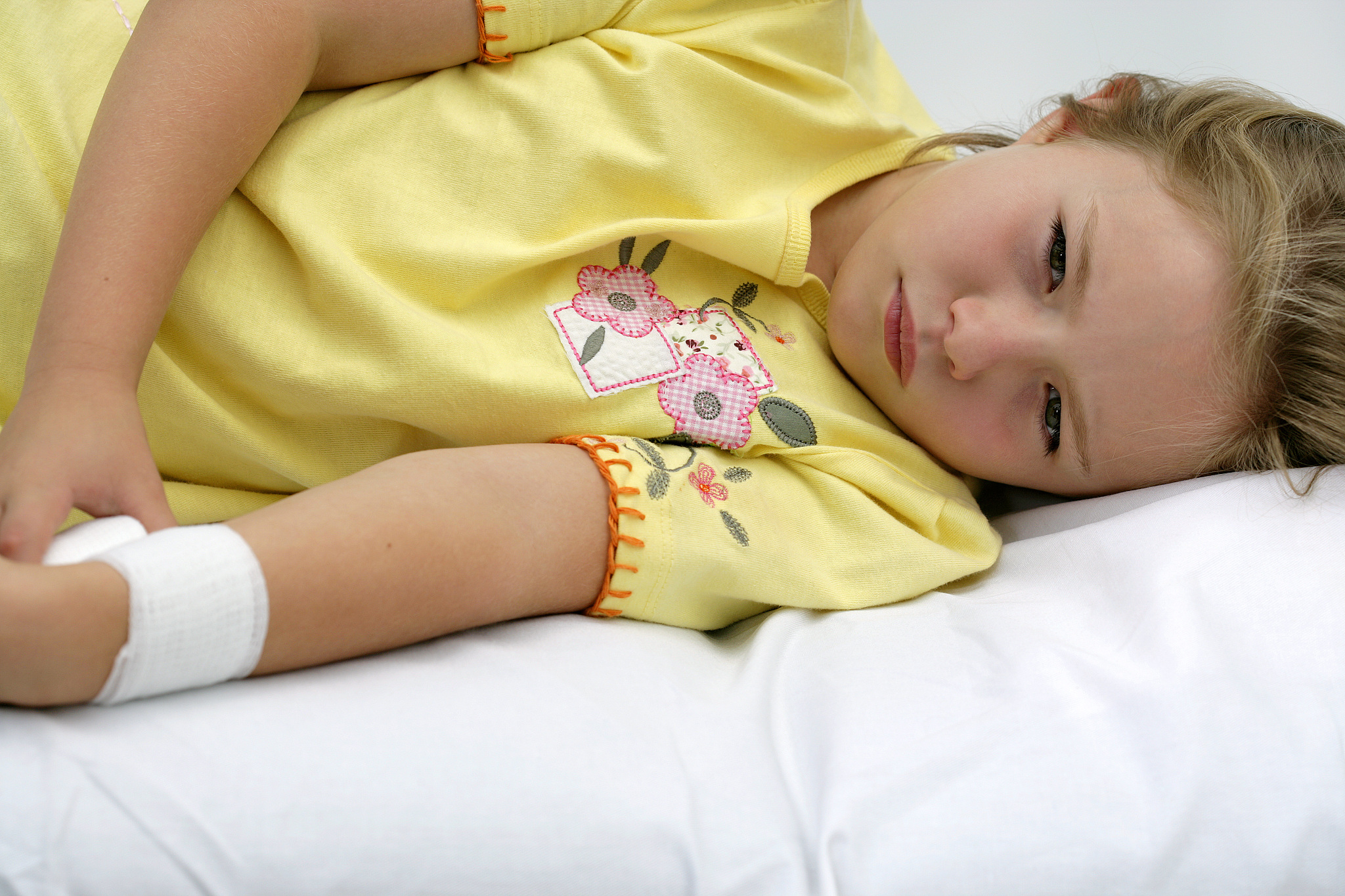girl with bandaged arm lying down