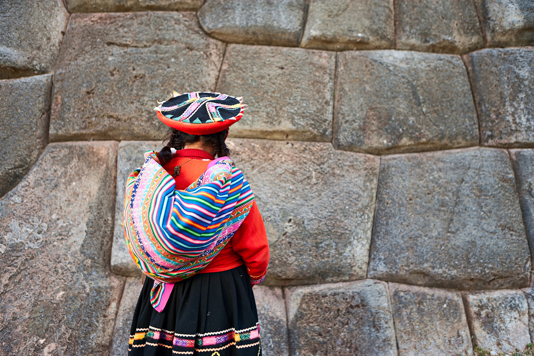 portrait of peruvian woman in national costume, sacsayhuaman